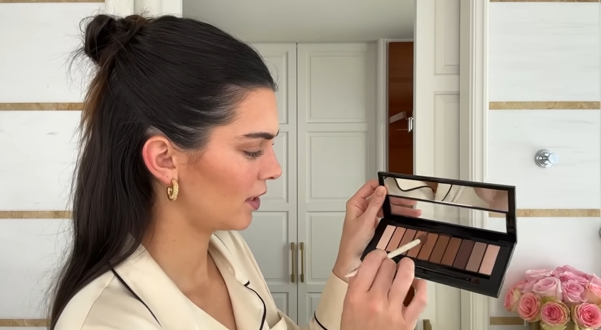 Kendall Jenner doing her Spring French girl makeup routine from a post dated April 11, 2024. | Source: YouTube\Vogue
