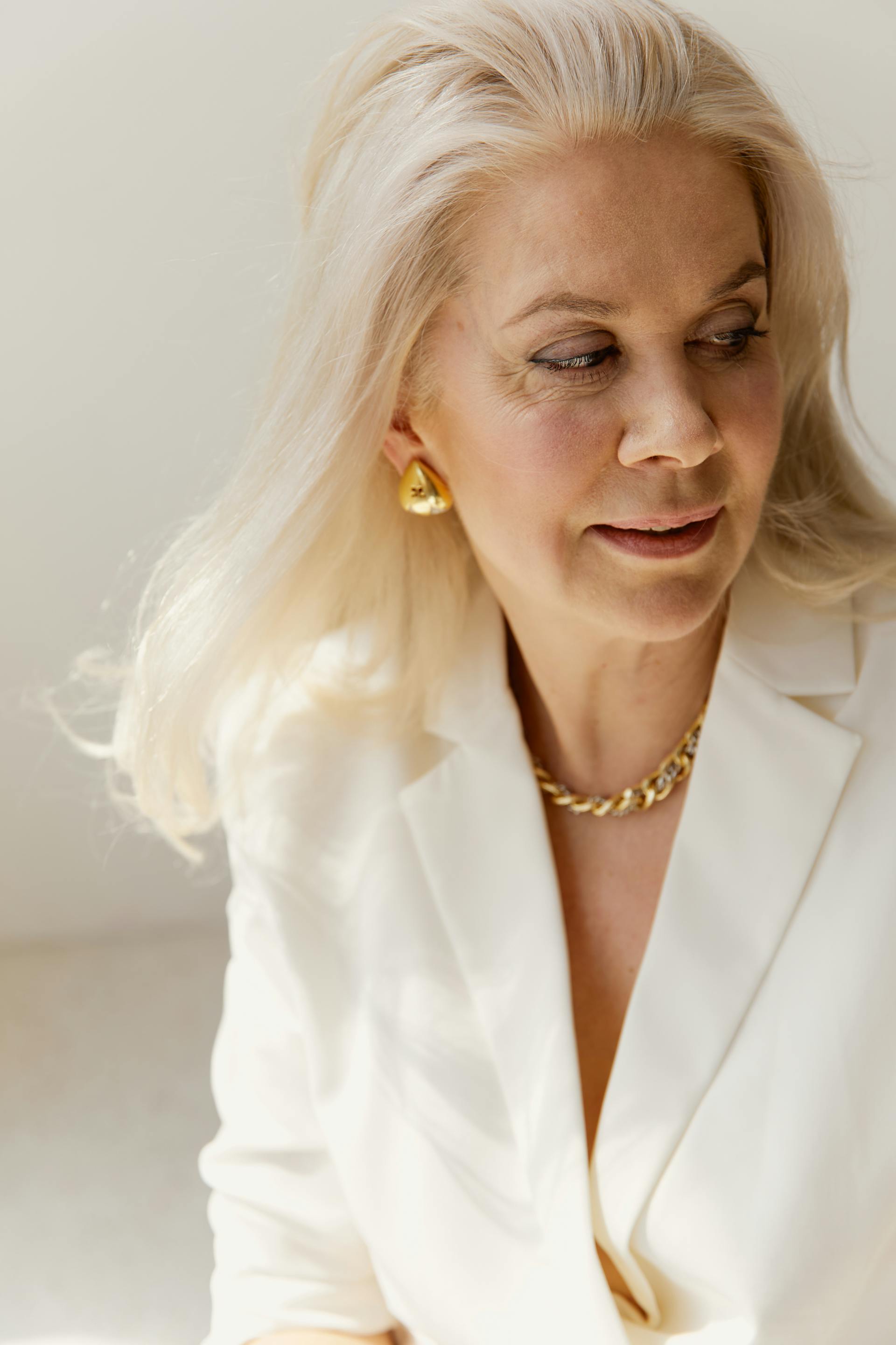 A woman in a white blazer looking at someone | Source: Pexels