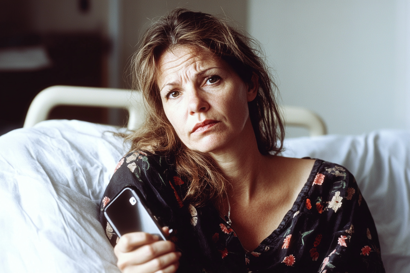 A woman holding a cell phone | Source: No source