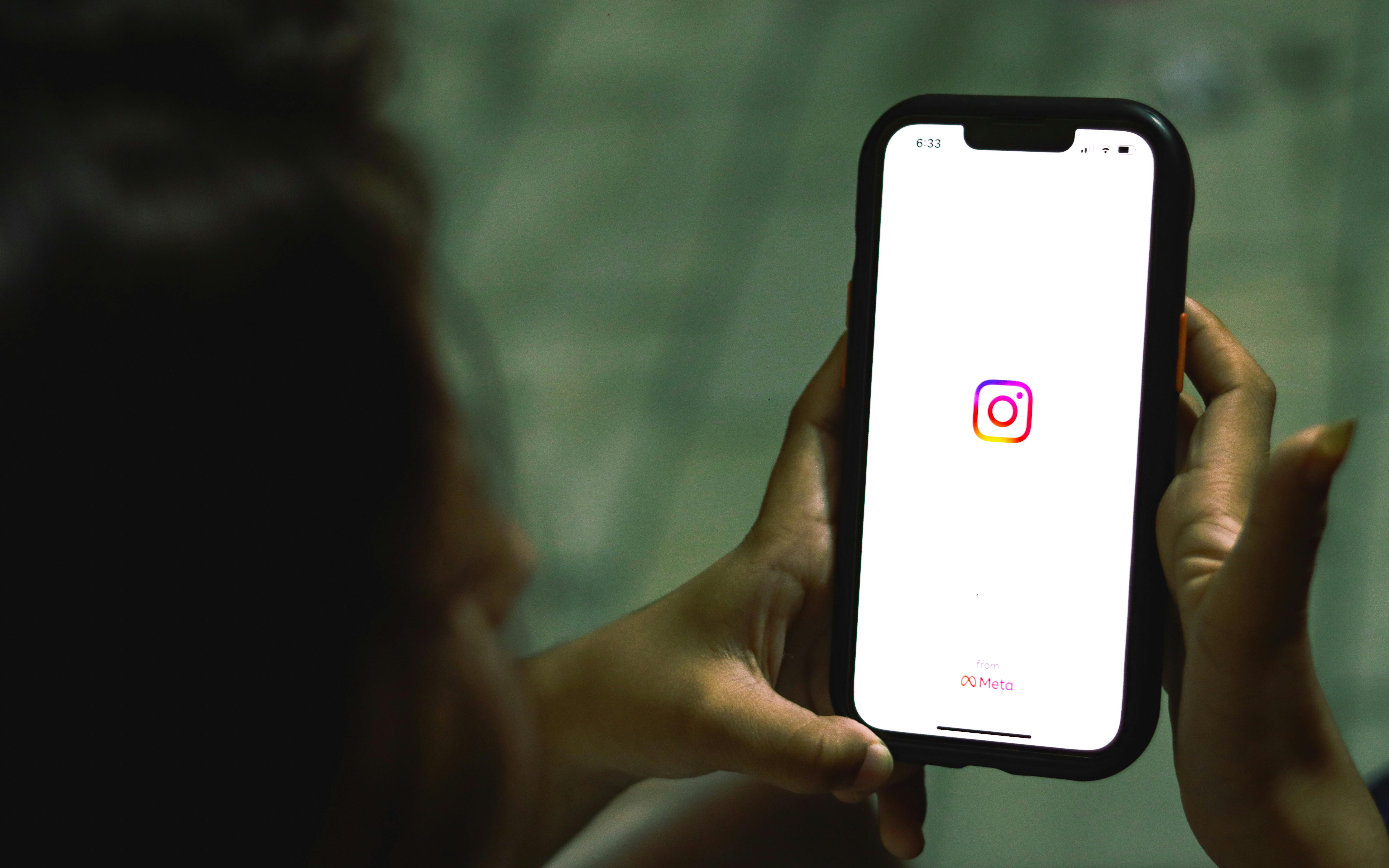 A woman opening Instagram on her phone | Source: Pexels