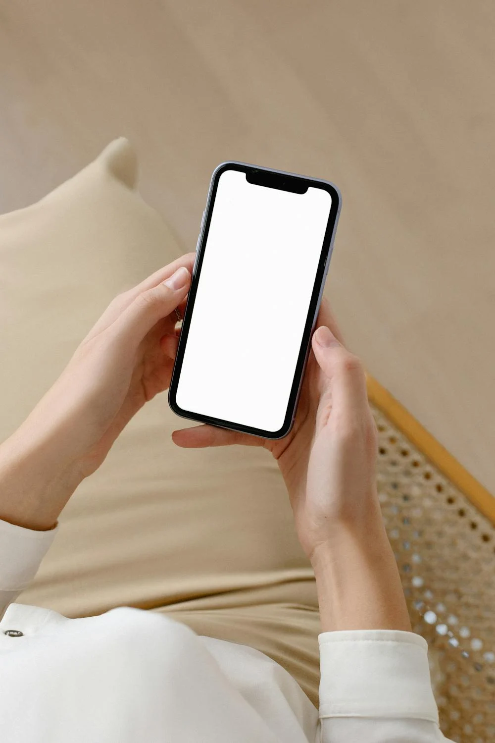 A woman holding a phone in her hands | Source: Pexels