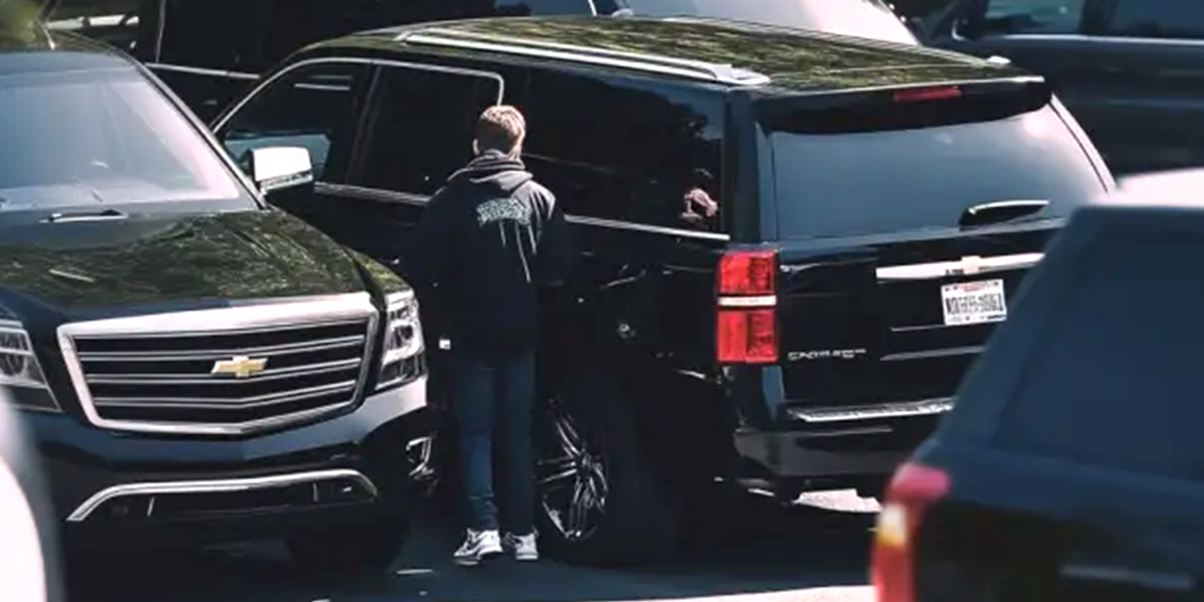 A teen boy getting into an SUV | Source: No source