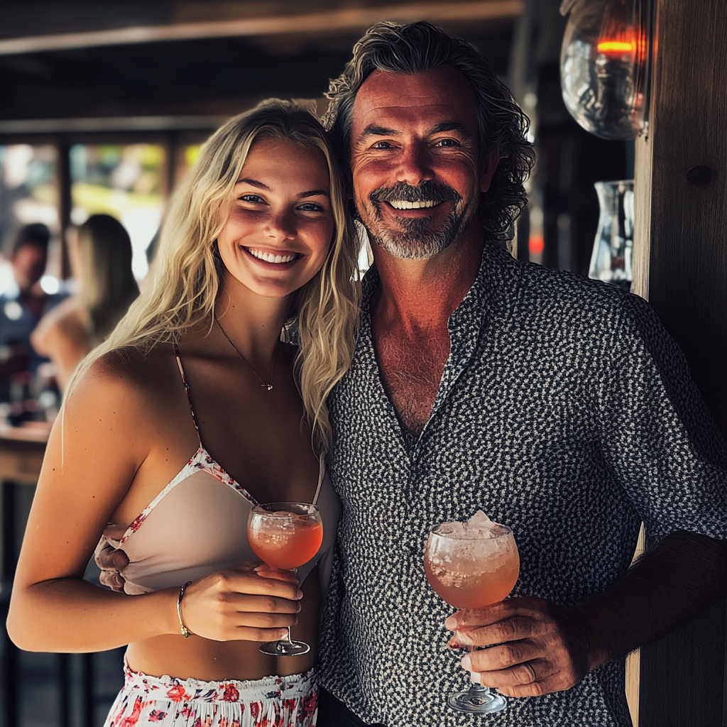 A couple holding drinks | Source: No source