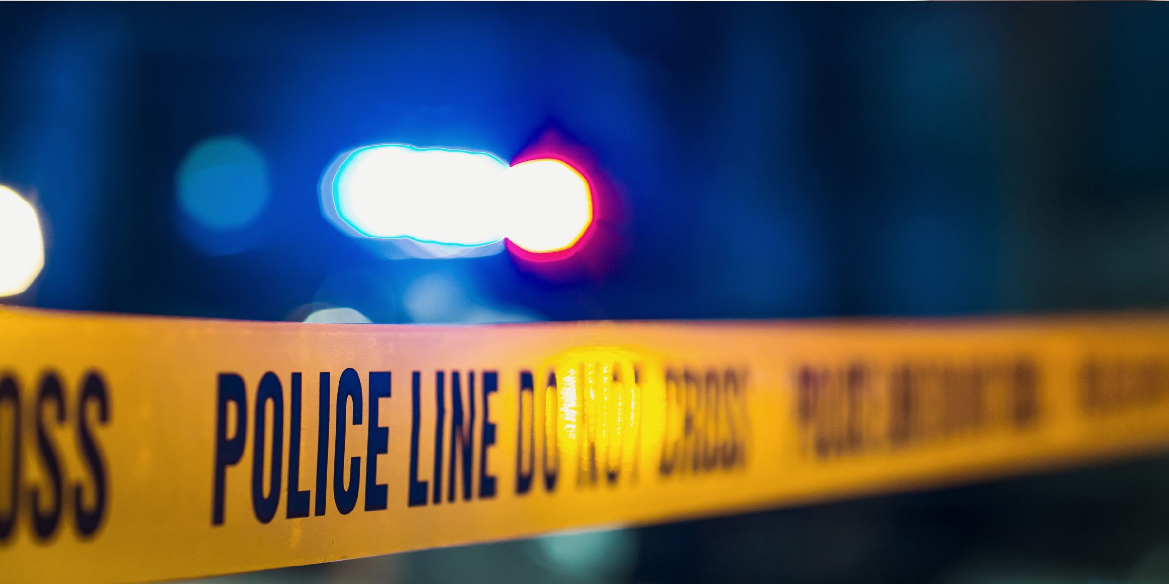 Close-up of a yellow tape with the text: "Police line do not cross" | Source: Shutterstock