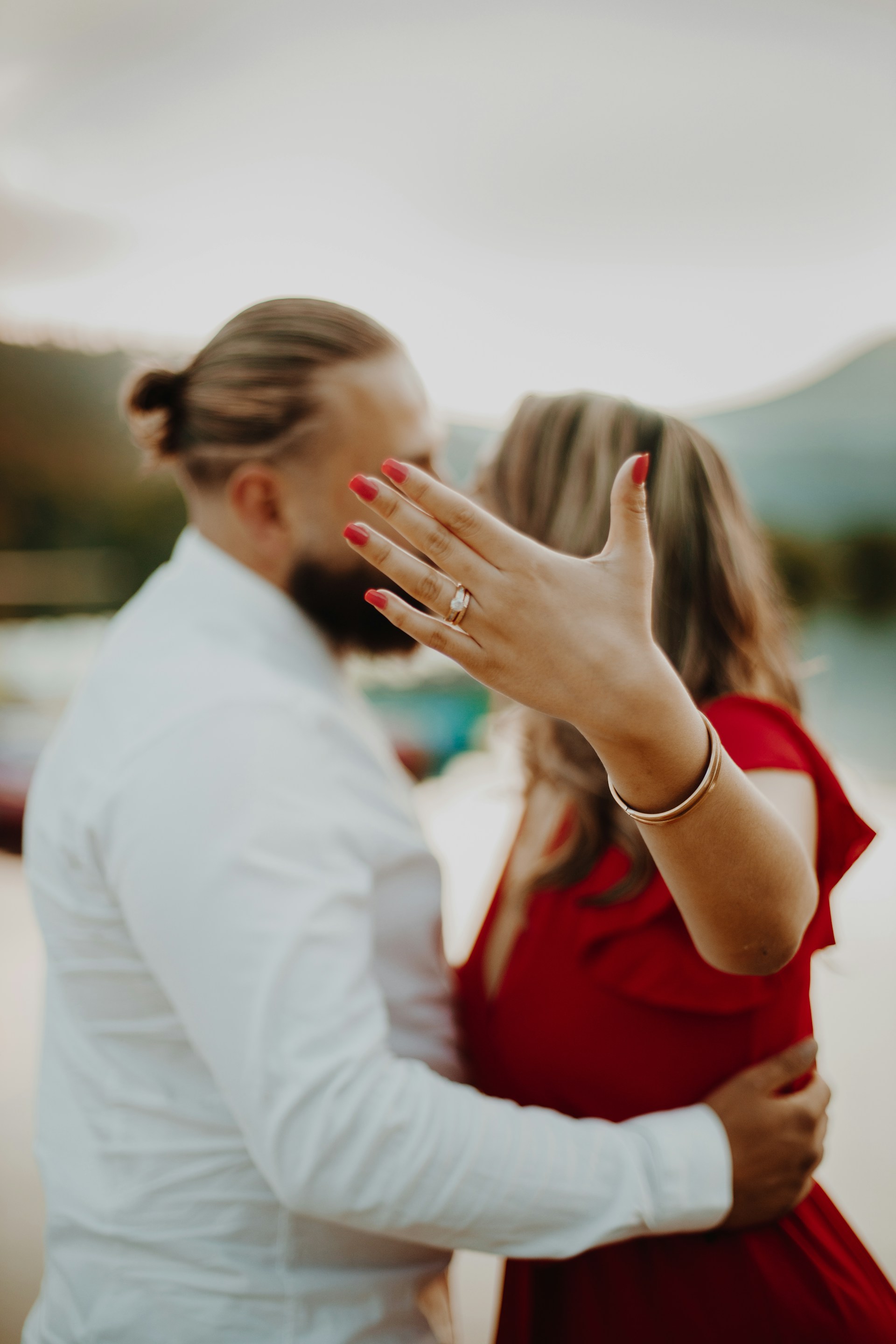 A woman standing with her partner and flaunting her engagement ring | Source: Unsplash