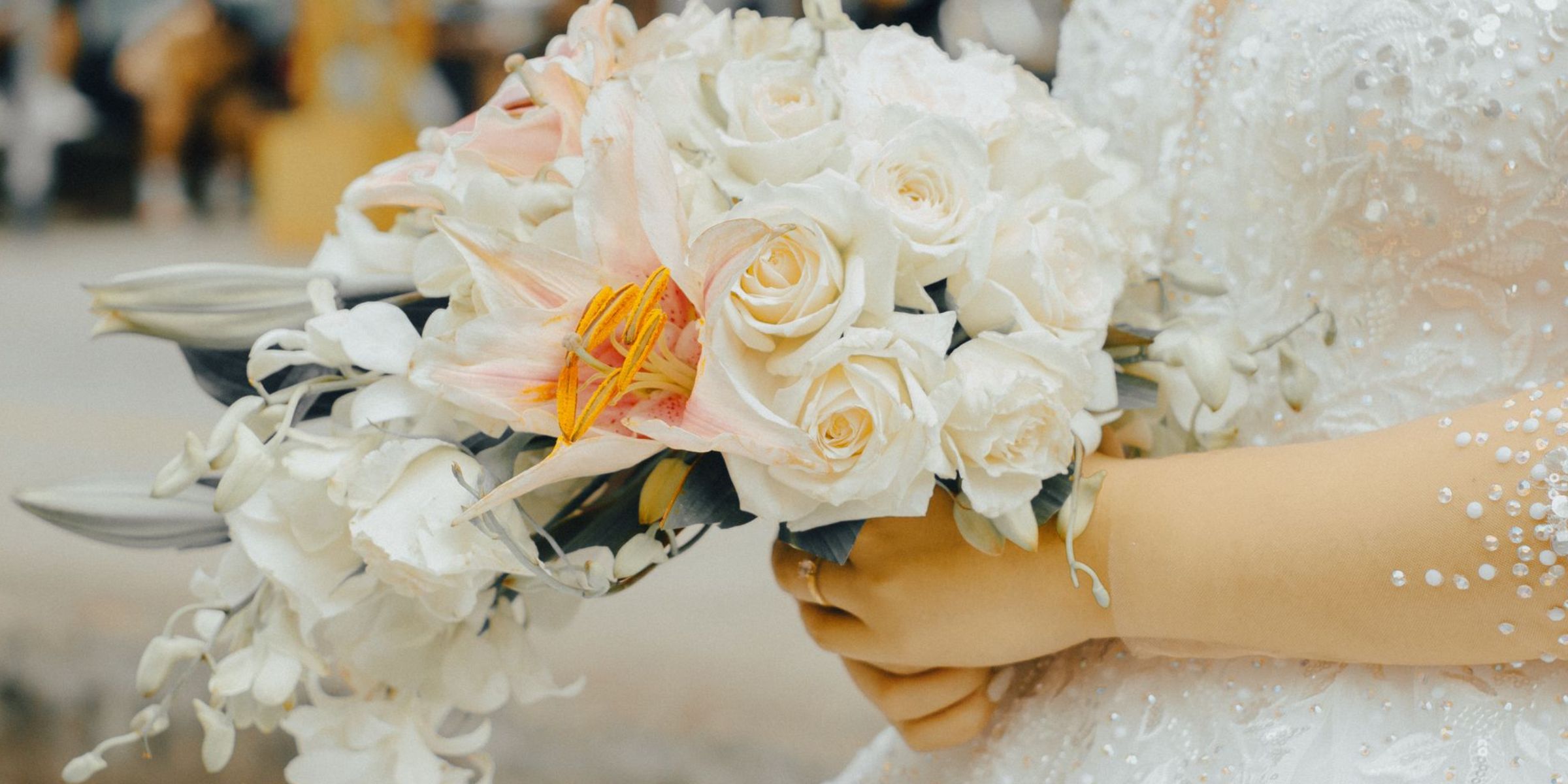 A bride holding an elegant bouquet of white flowers while dressed in a wedding gown | Source: Pexels