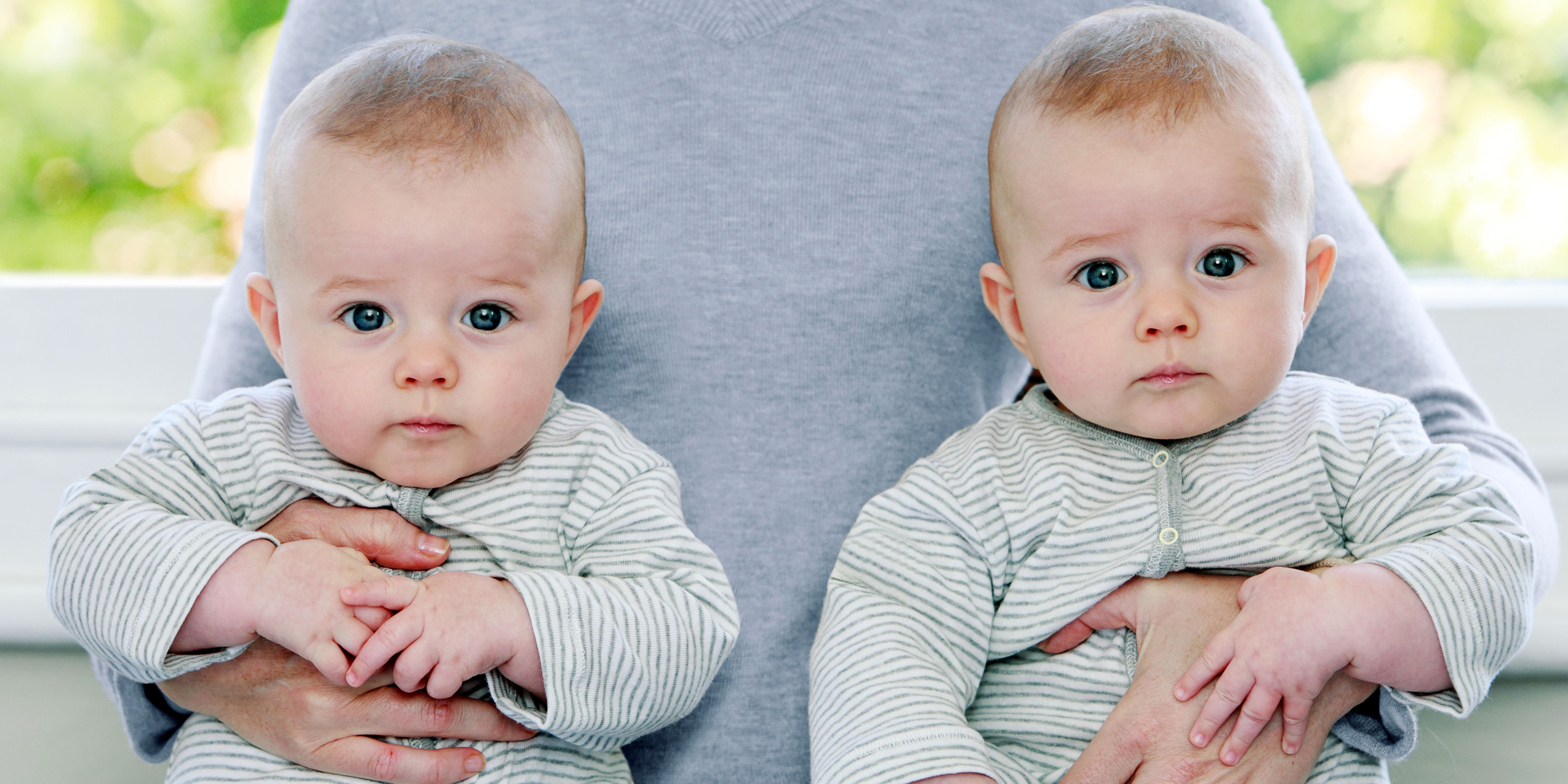 A man holding twin baby boys. | Source: Shutterstock