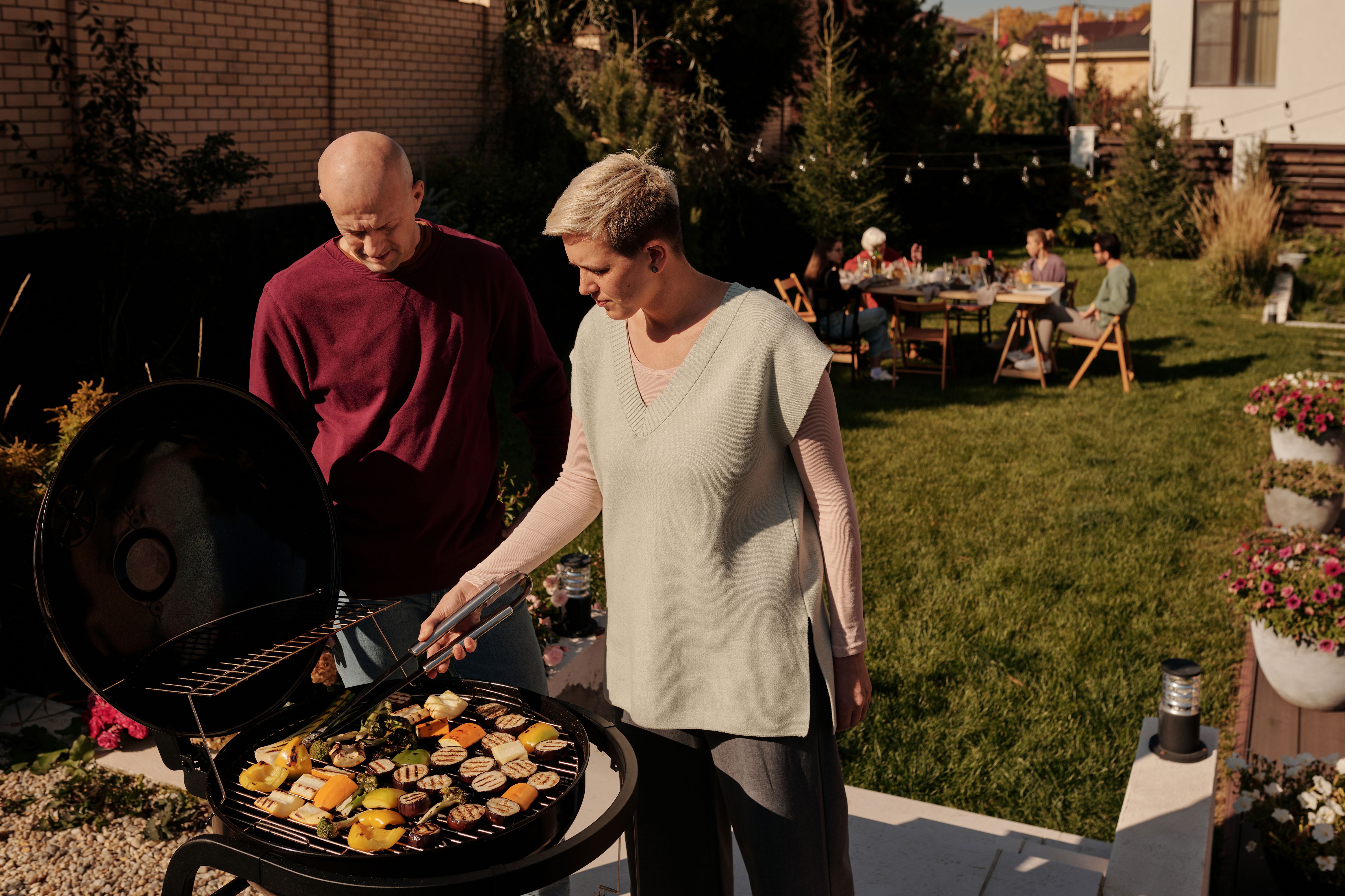 A man and a woman having a barbecue | Source: Pexels