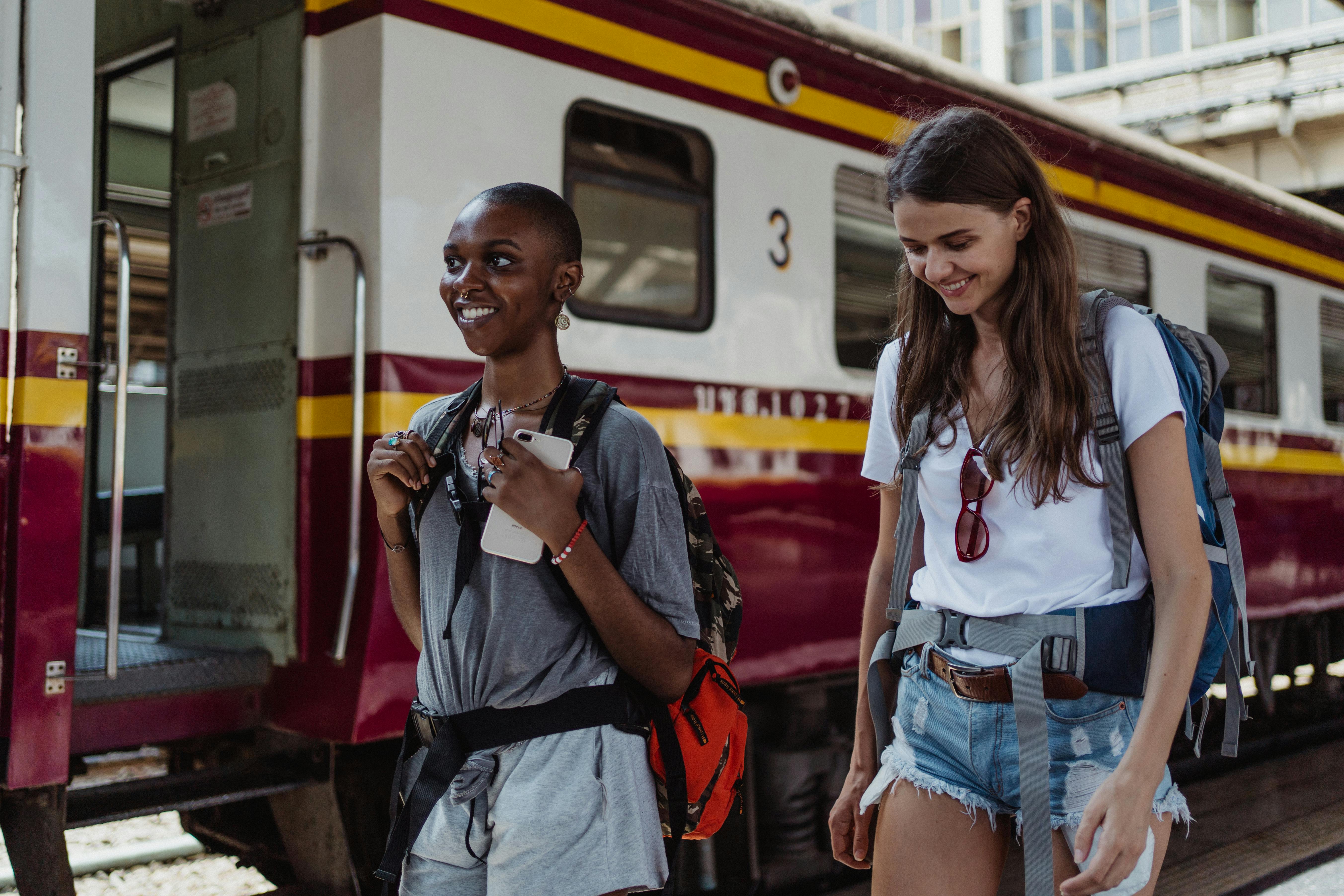 Women walking next to a train | Source: Pexels