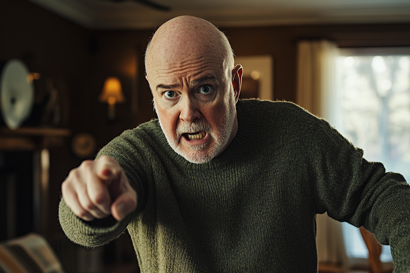 An older man angrily pointing a finger in a living room | Source: no source