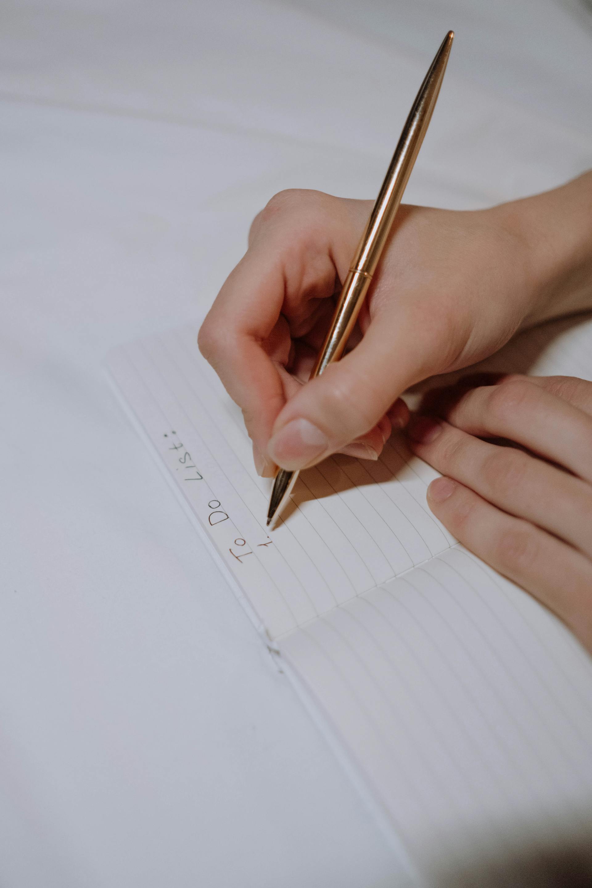 A woman writing a to-do list | Source: Pexels