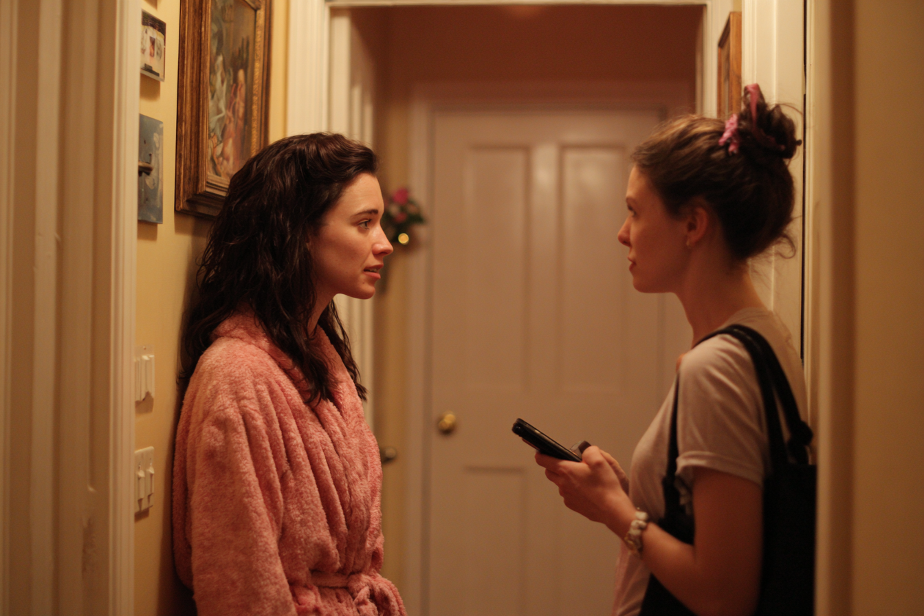 Two women speaking in a home hallway | Source: No source