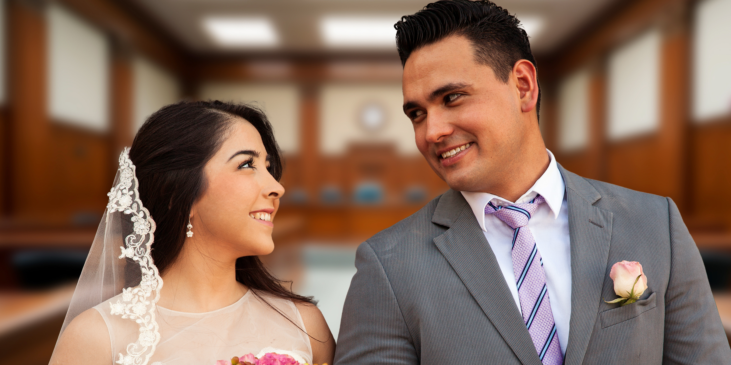 A smiling couple at a courthouse | Source: Shutterstock