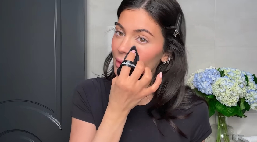 Kylie Jenner doing her classic beauty routine from a video dated April 6, 2023. | Source: YouTube/Vogue