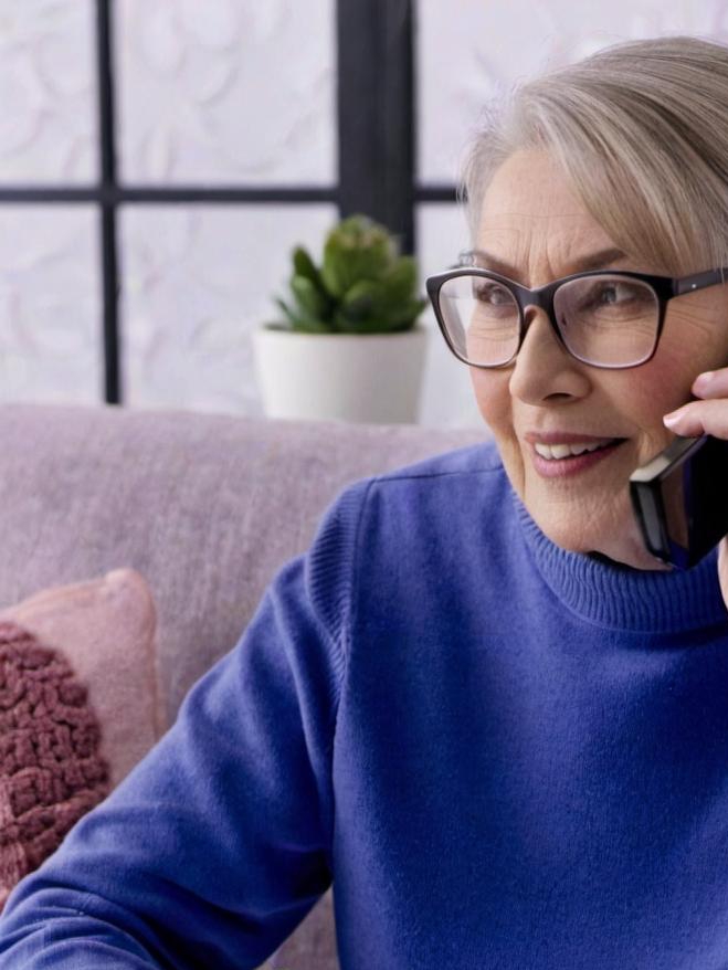 An elderly woman placing a phone call | Source: no source