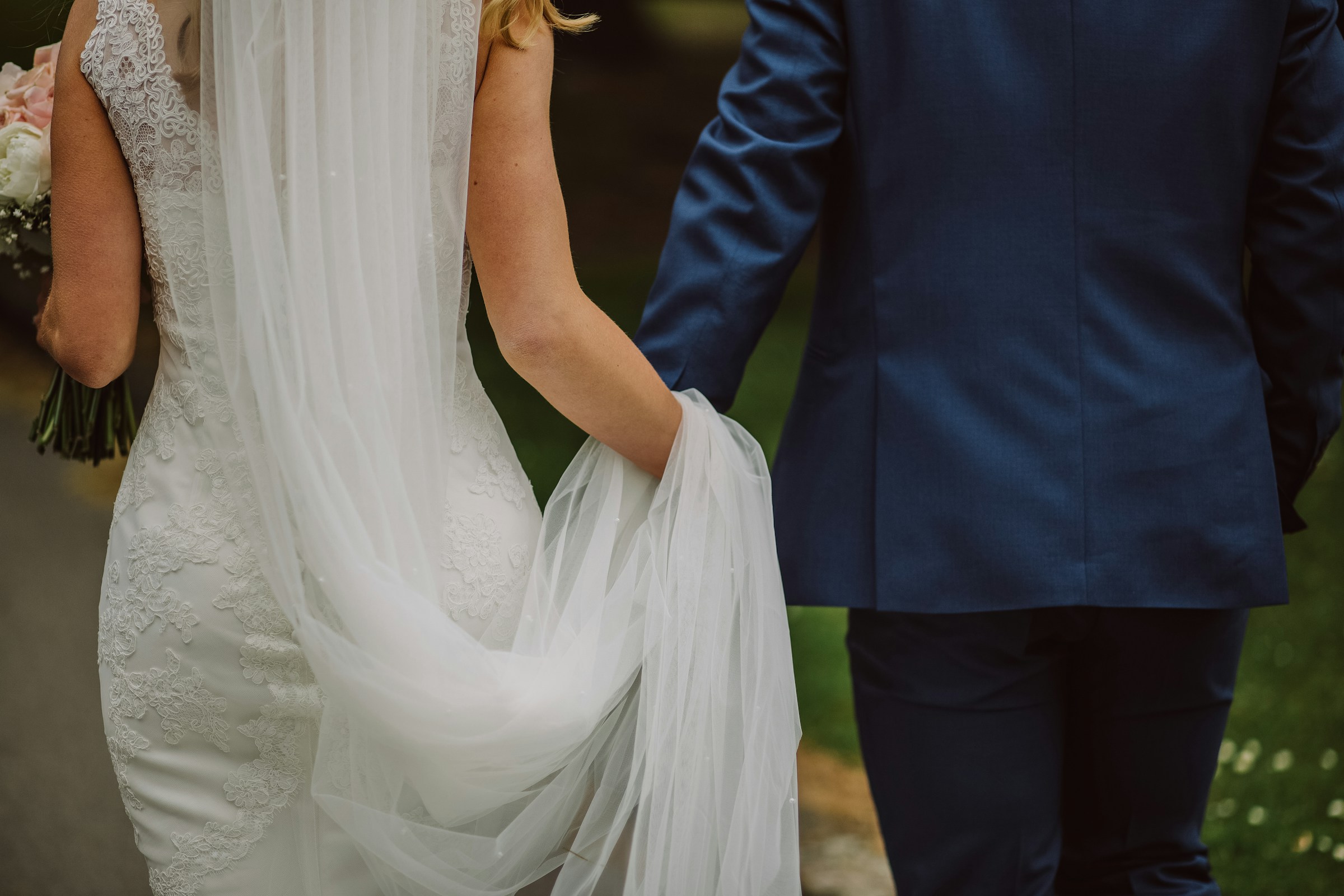 A bride and groom holding hands while walking | Source: Unsplash