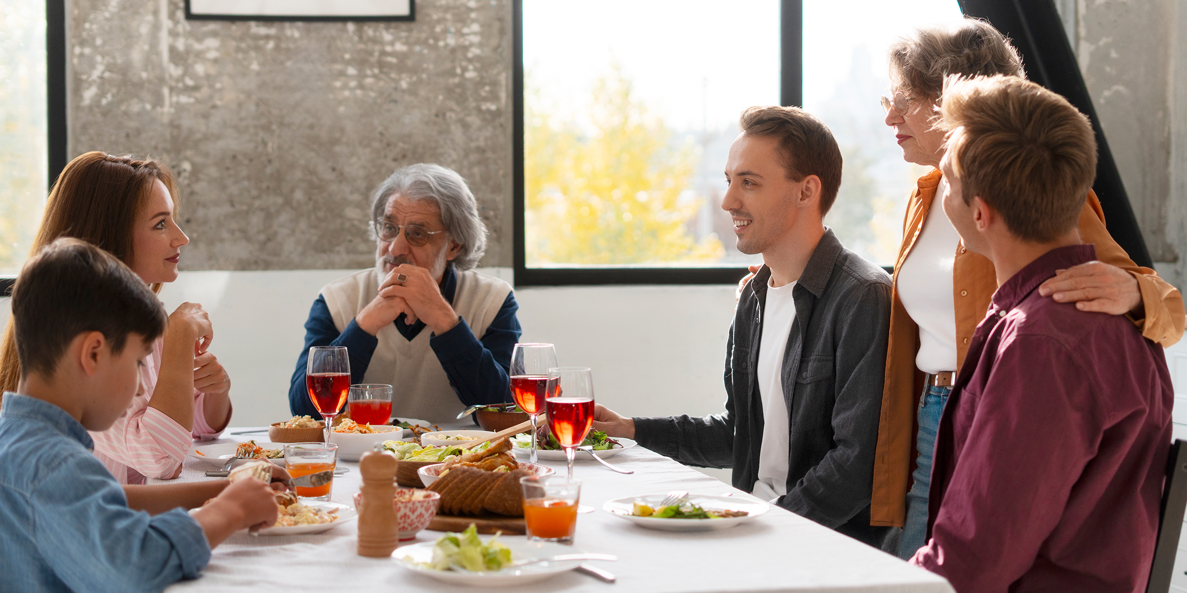 A family sitting around a table | Source: Freepik