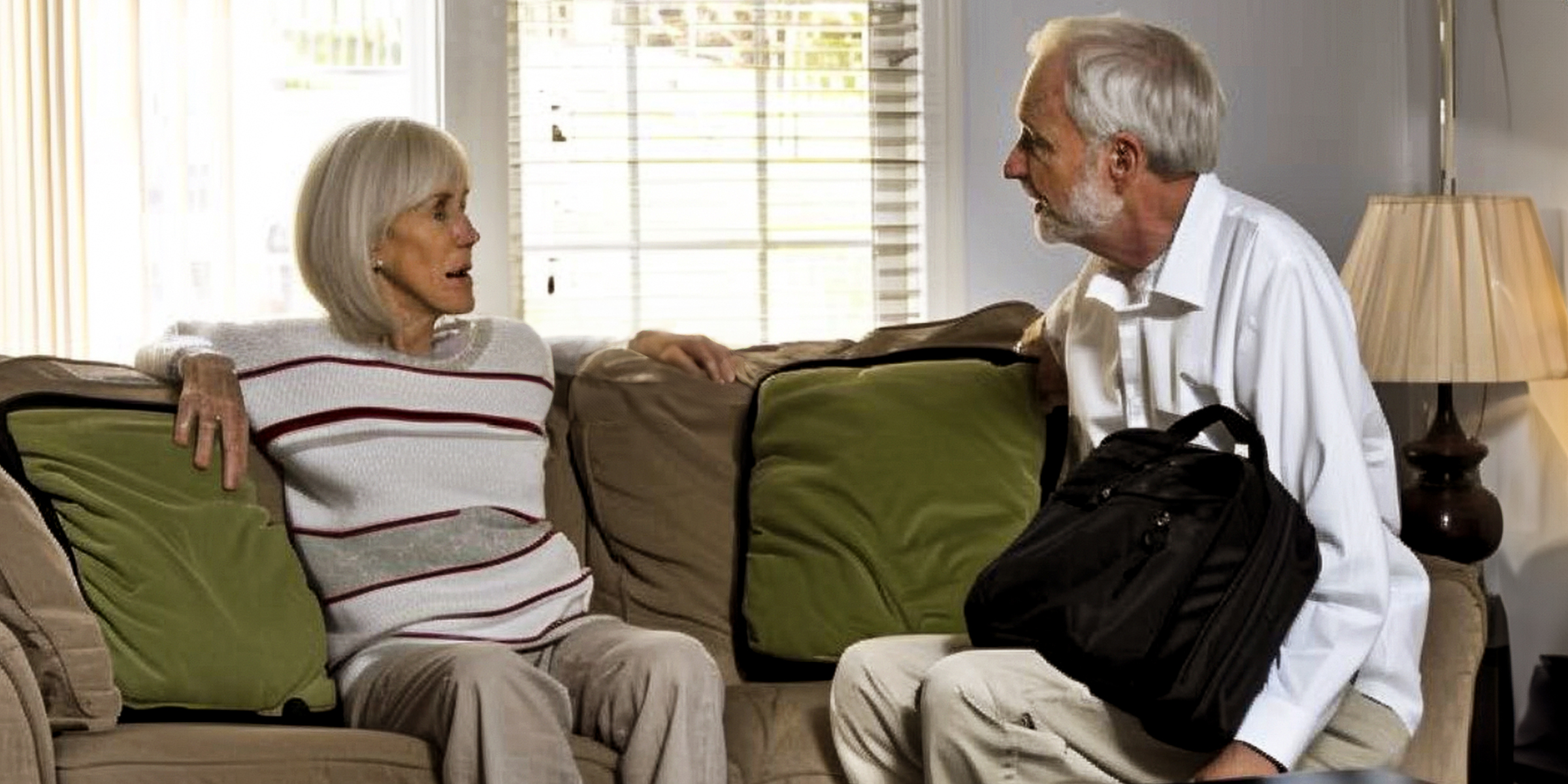 An elderly couple sitting on a couch | Source: No source