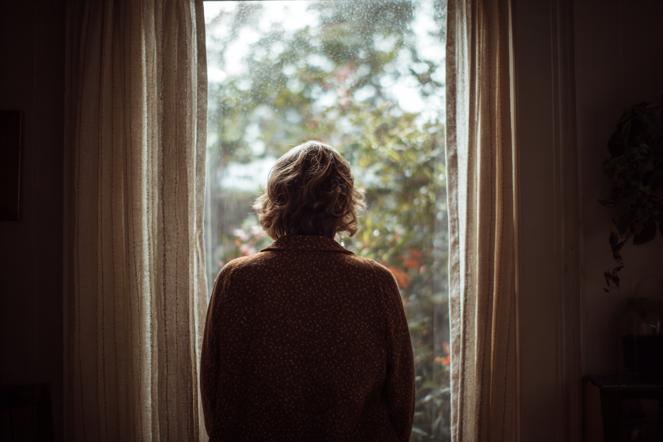 A woman looking out of a window | Source: no source