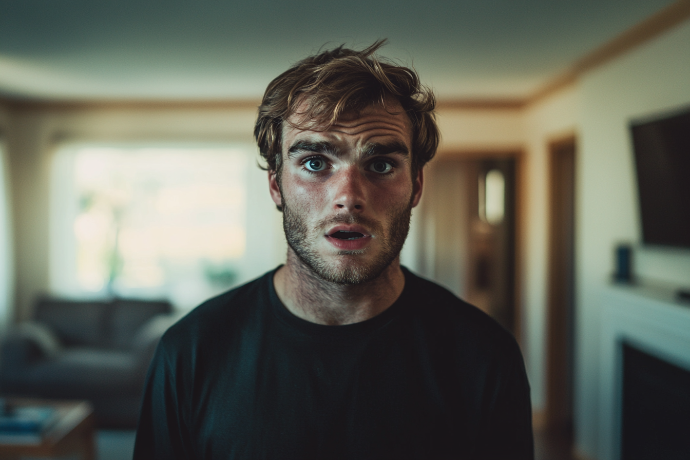A shocked man in a living room | Source: no source