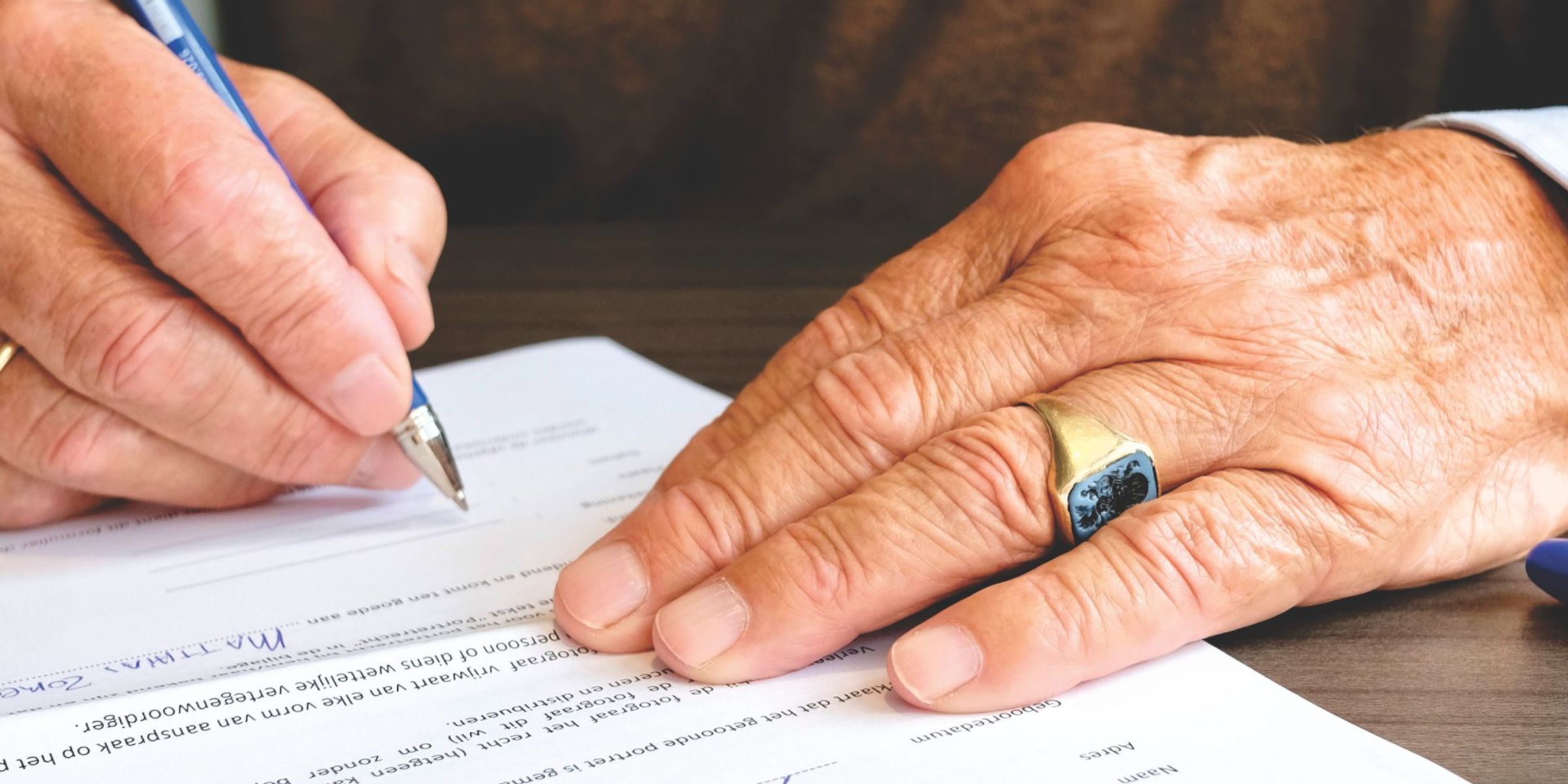 A person signing documents | Source: Pexels