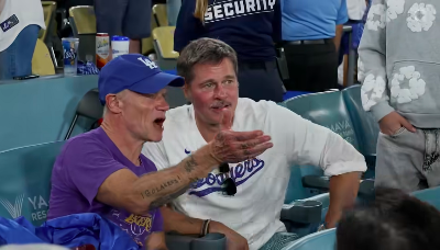 Flea  talking to Brad Pitt as the two watch the game between the Los Angeles Dodgers and the Toronto Blue Jays. | Source: Facebook/Sportsnet
