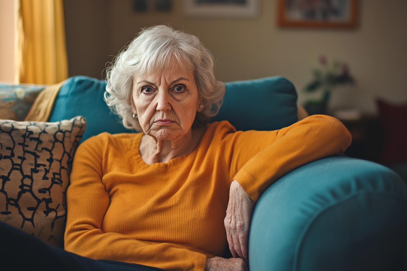 A scowling woman on a sofa | Source: no source
