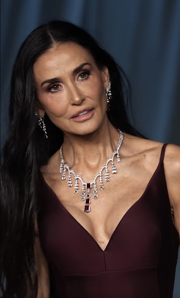 In a still, almost statuesque moment, Demi Moore looks on with a composed gaze, the dramatic angle of her collarbone and the shimmer of her necklace capturing the camera's full attention in this sharp close-up. | Source: Facebook/TooFab