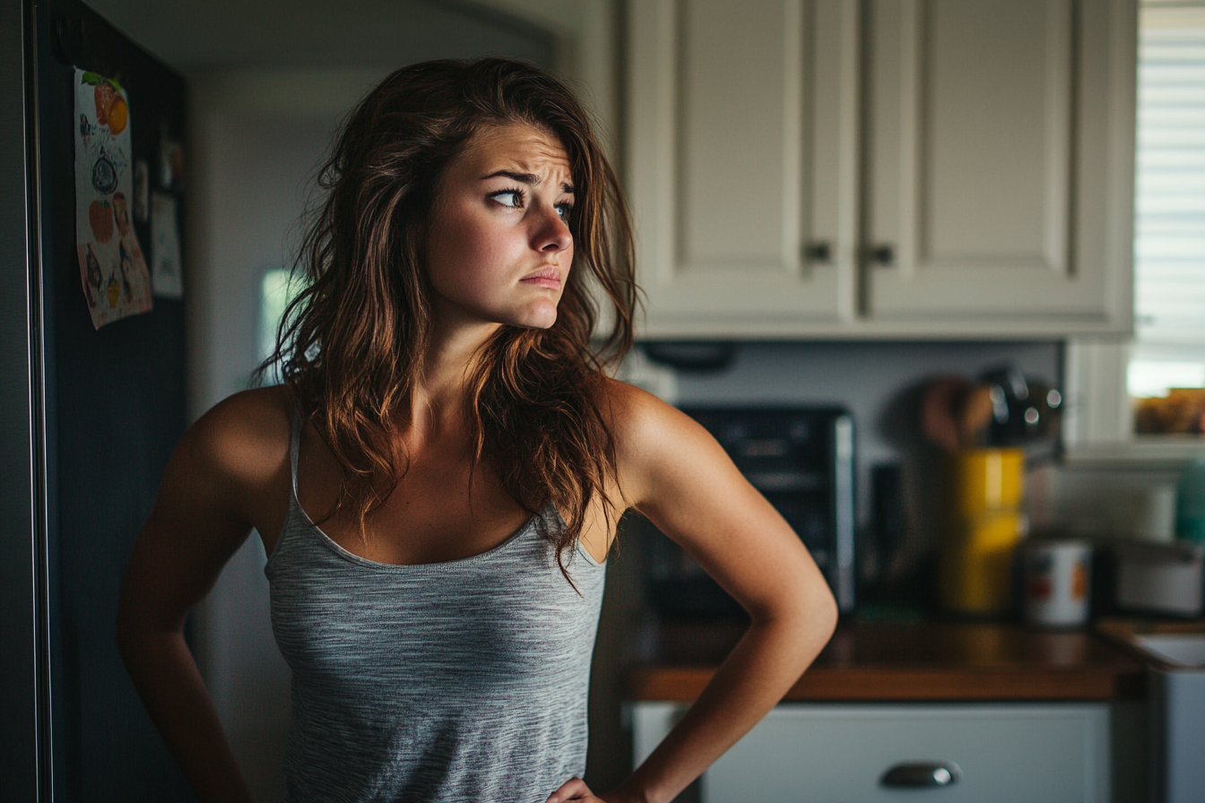 A concerned woman in a kitchen | Source: No source