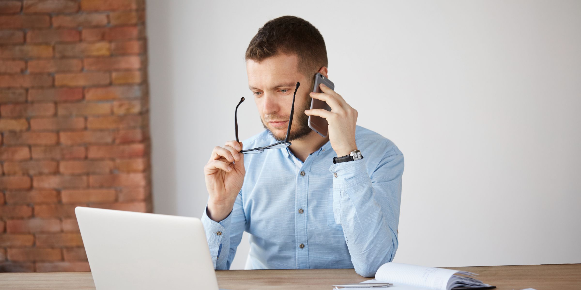 A serious man on a call while working on his laptop | Source: No source