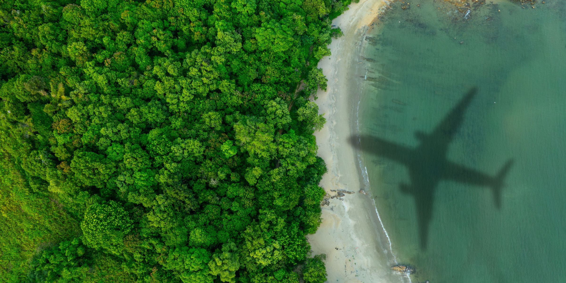 Aerial view of shadow passenger plane silhouette | Source: Shutterstock