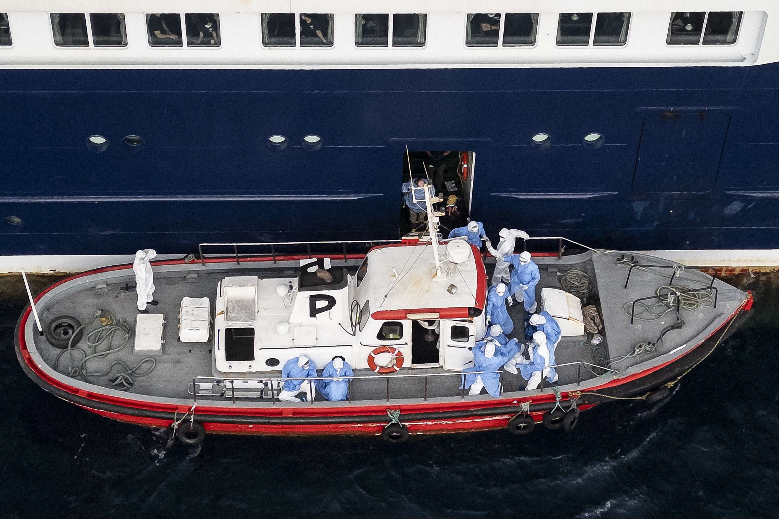 Aerial view shows health personnel assisting patients onto a boat from the cruise ship MV Hondius, while stationary off the port of Praia, the capital of Cape Verde, on May 6, 2026. |  Source: Getty Images