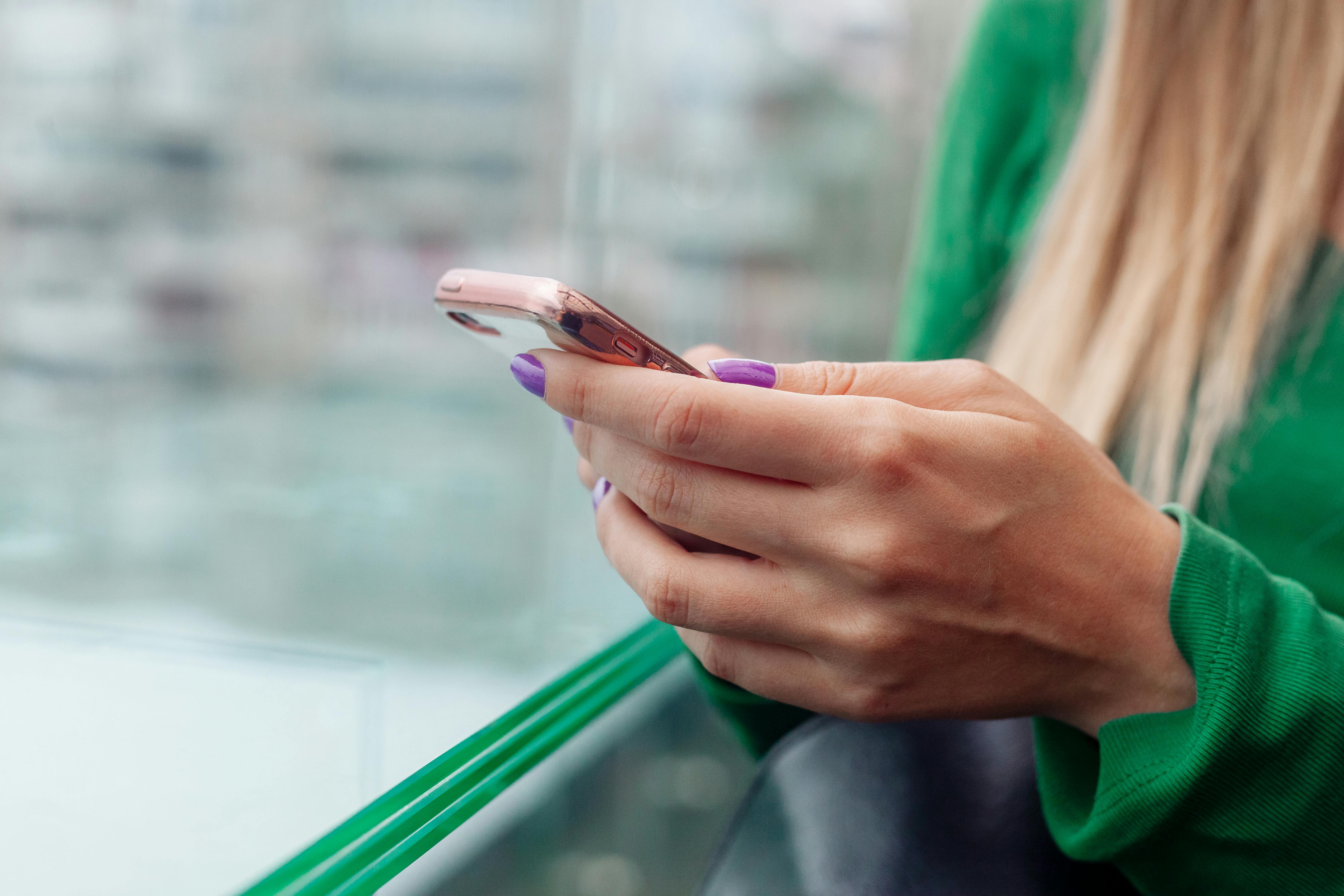 A woman holding a phone | Source: Pexels