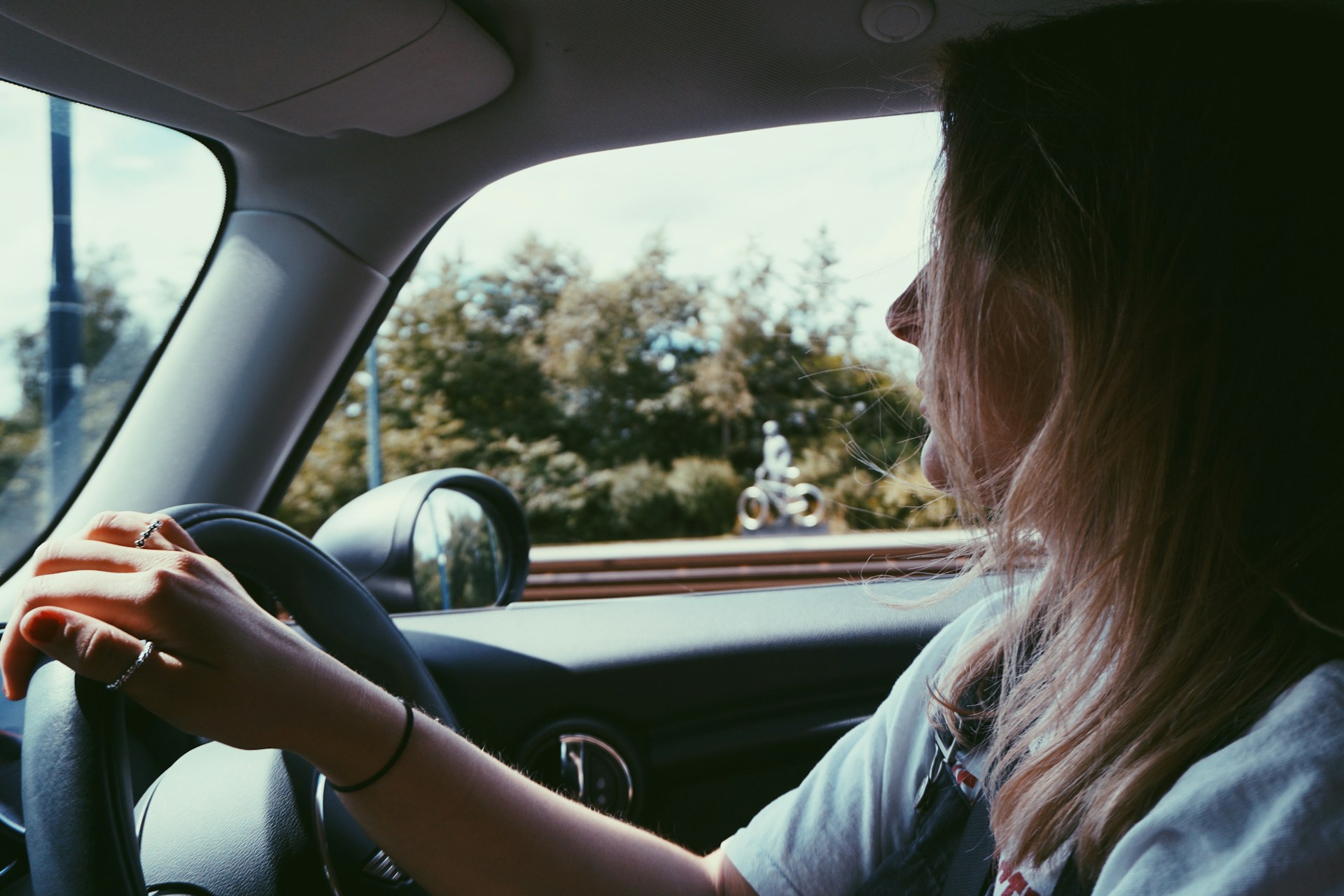 A cheerful woman driving a car | Source: Unsplash