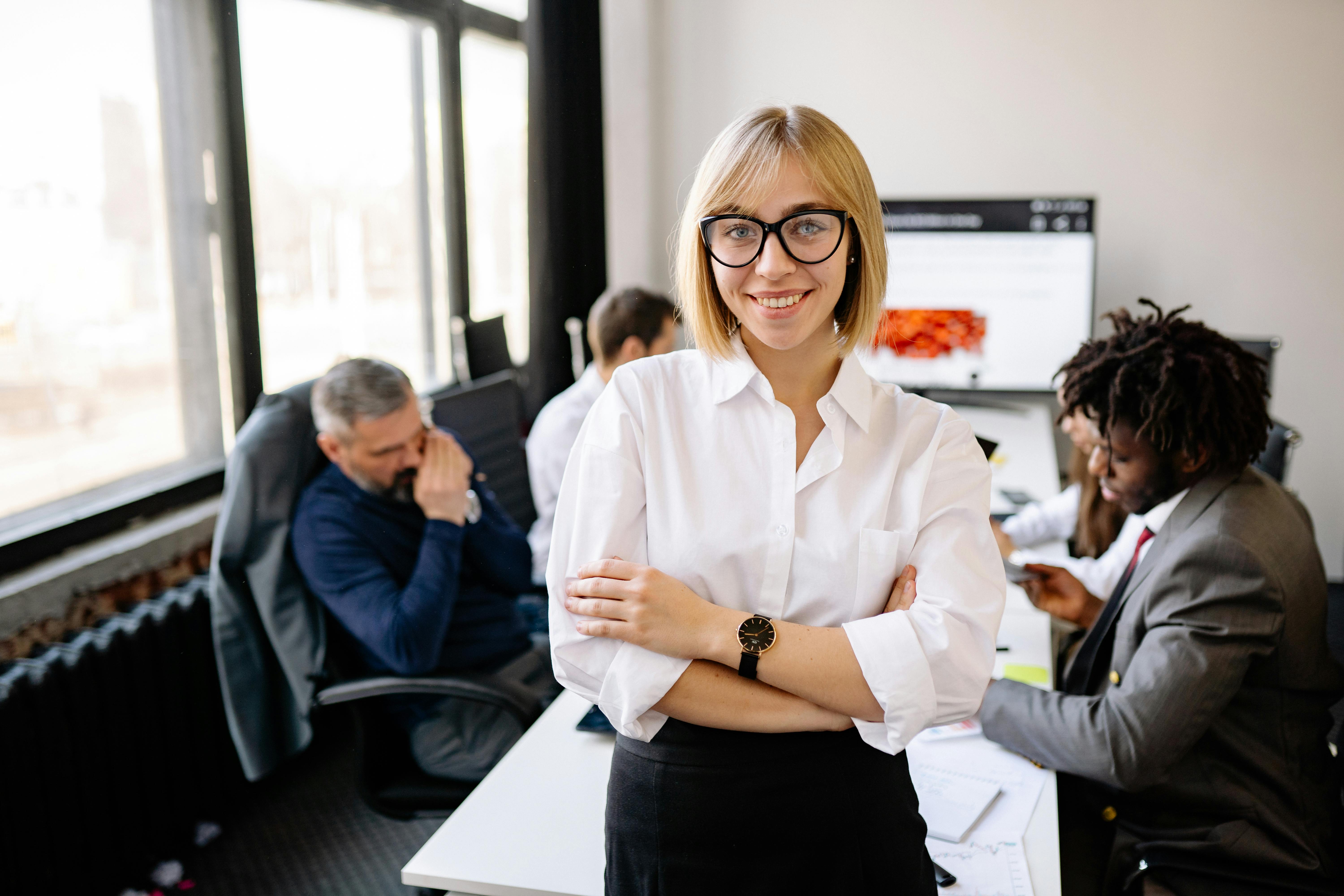 Woman posing in front of a group of people | Source: Pexels