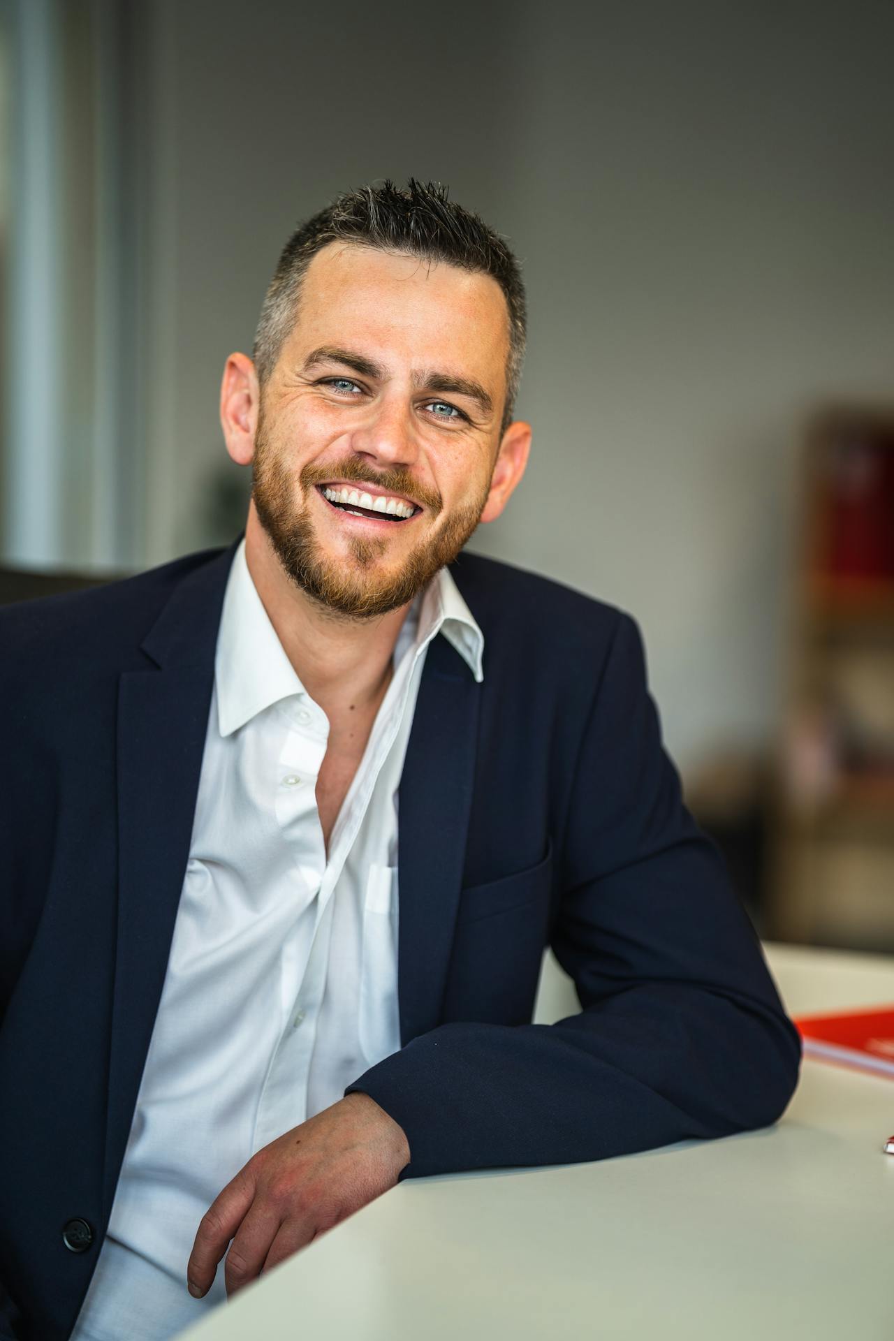 A smiling man in his office | Source: Pexels