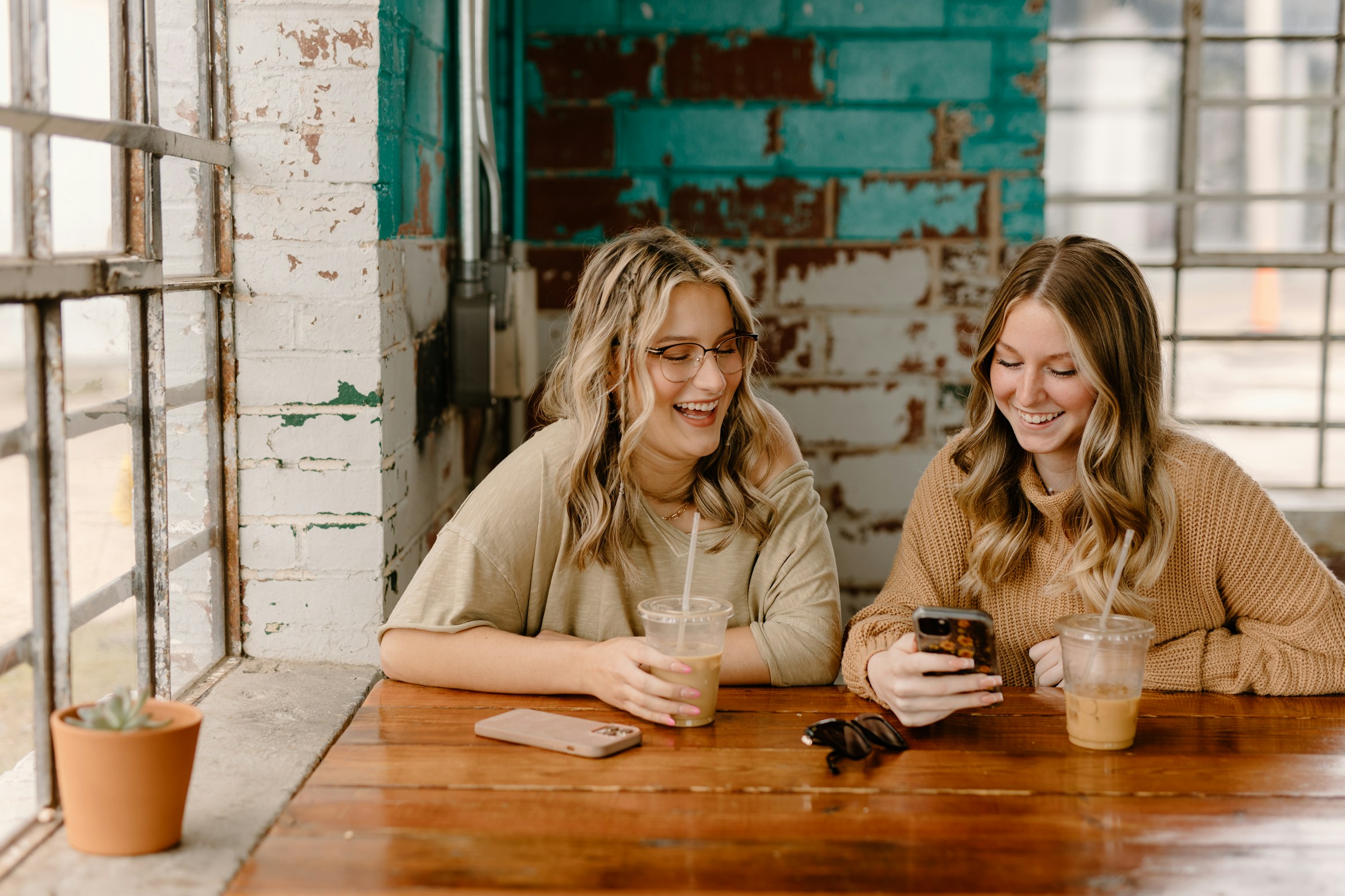 Friends having coffee and smiling | Source: Unsplash