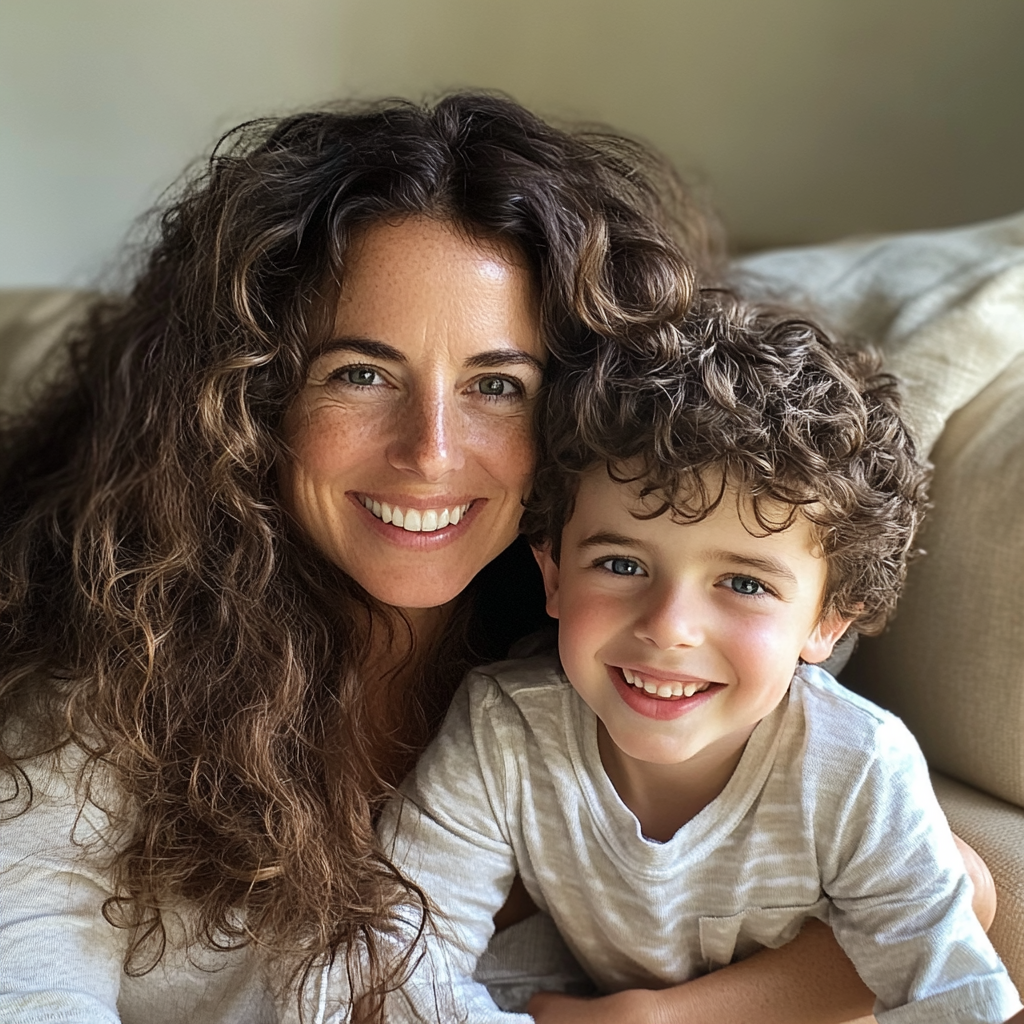 A woman and her son sitting on a couch | Source: No source