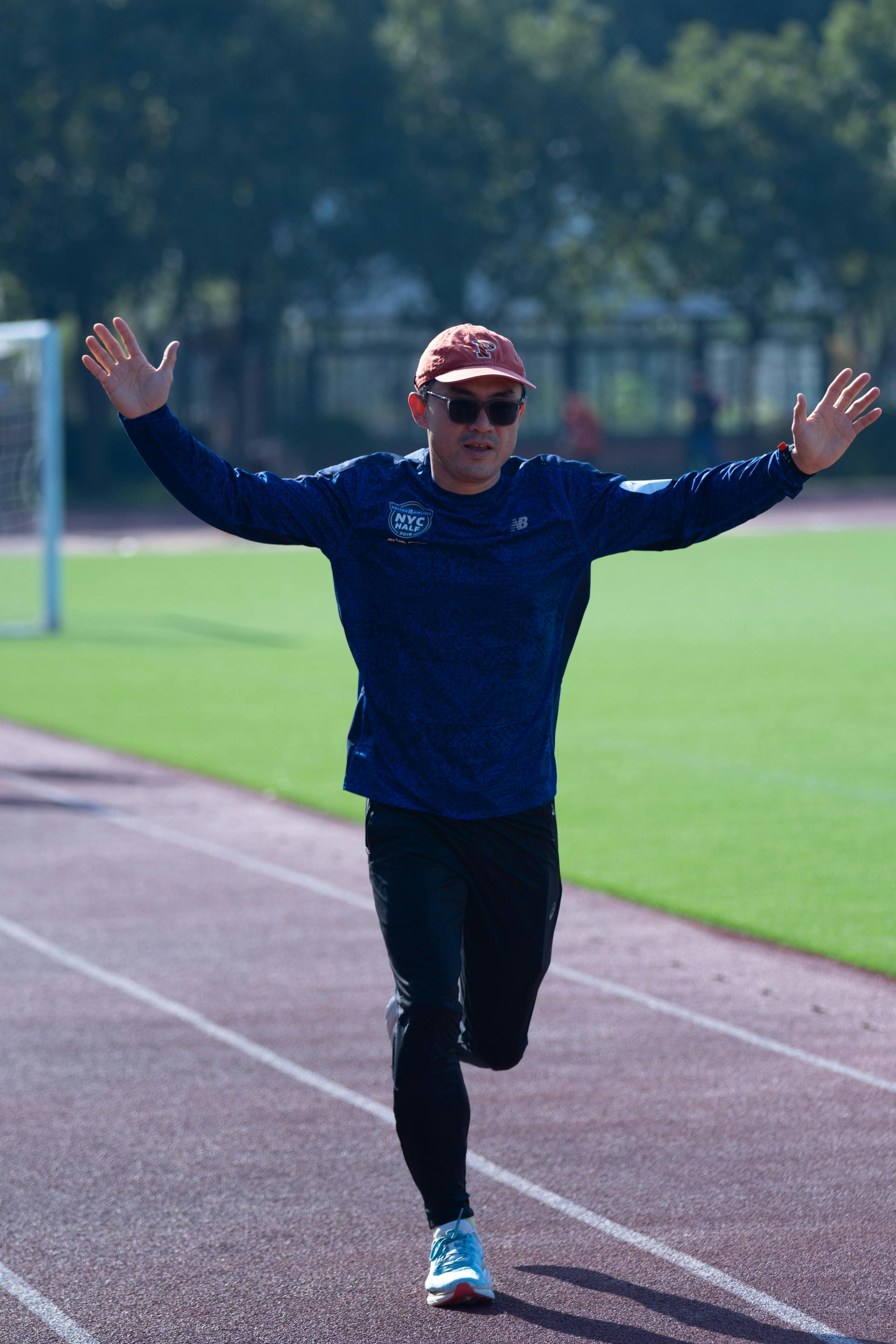Runner celebrating on an outdoor track | Source: Pexels