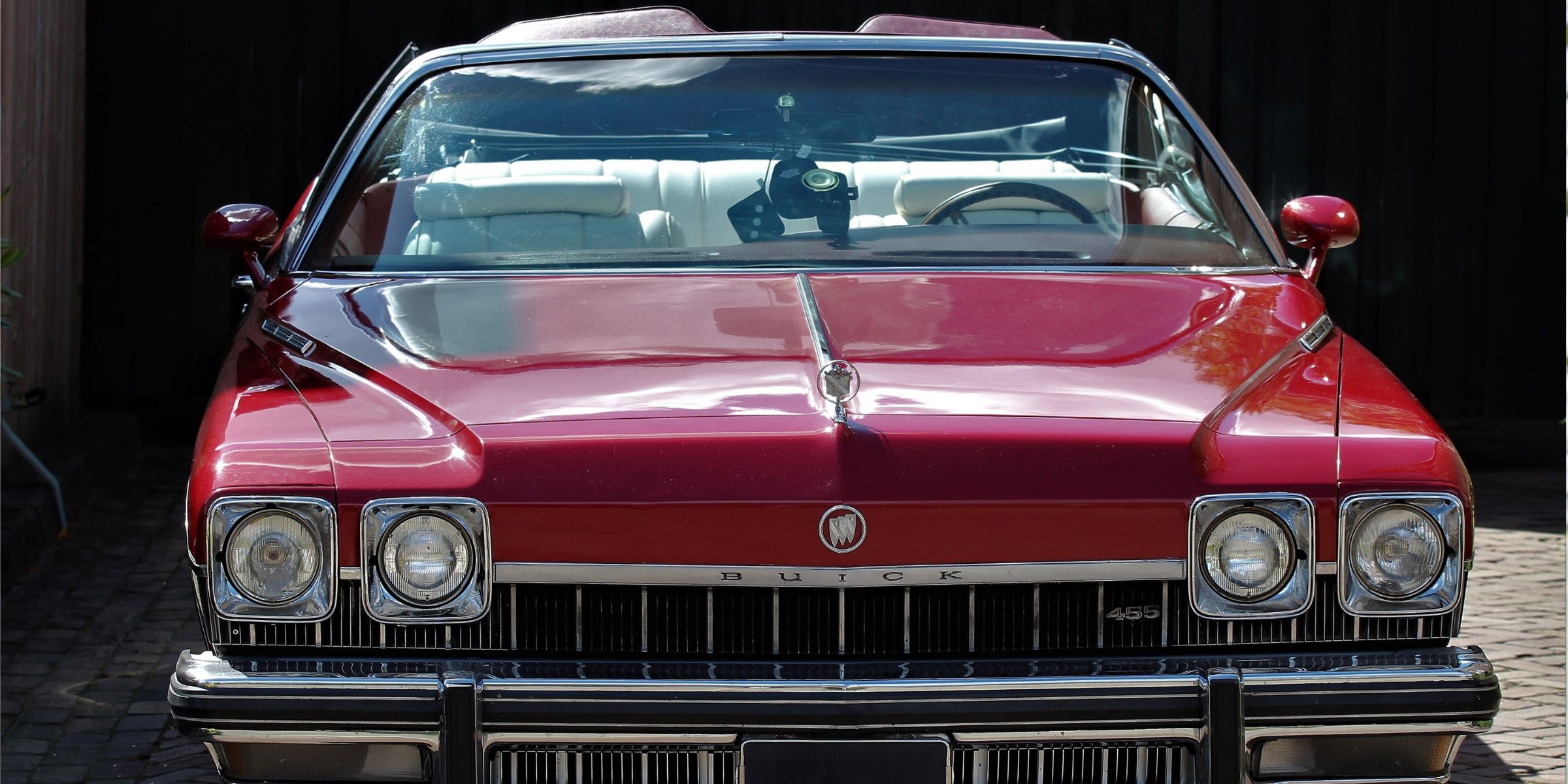 A classic red vintage convertible parked outdoors | Source: No source
