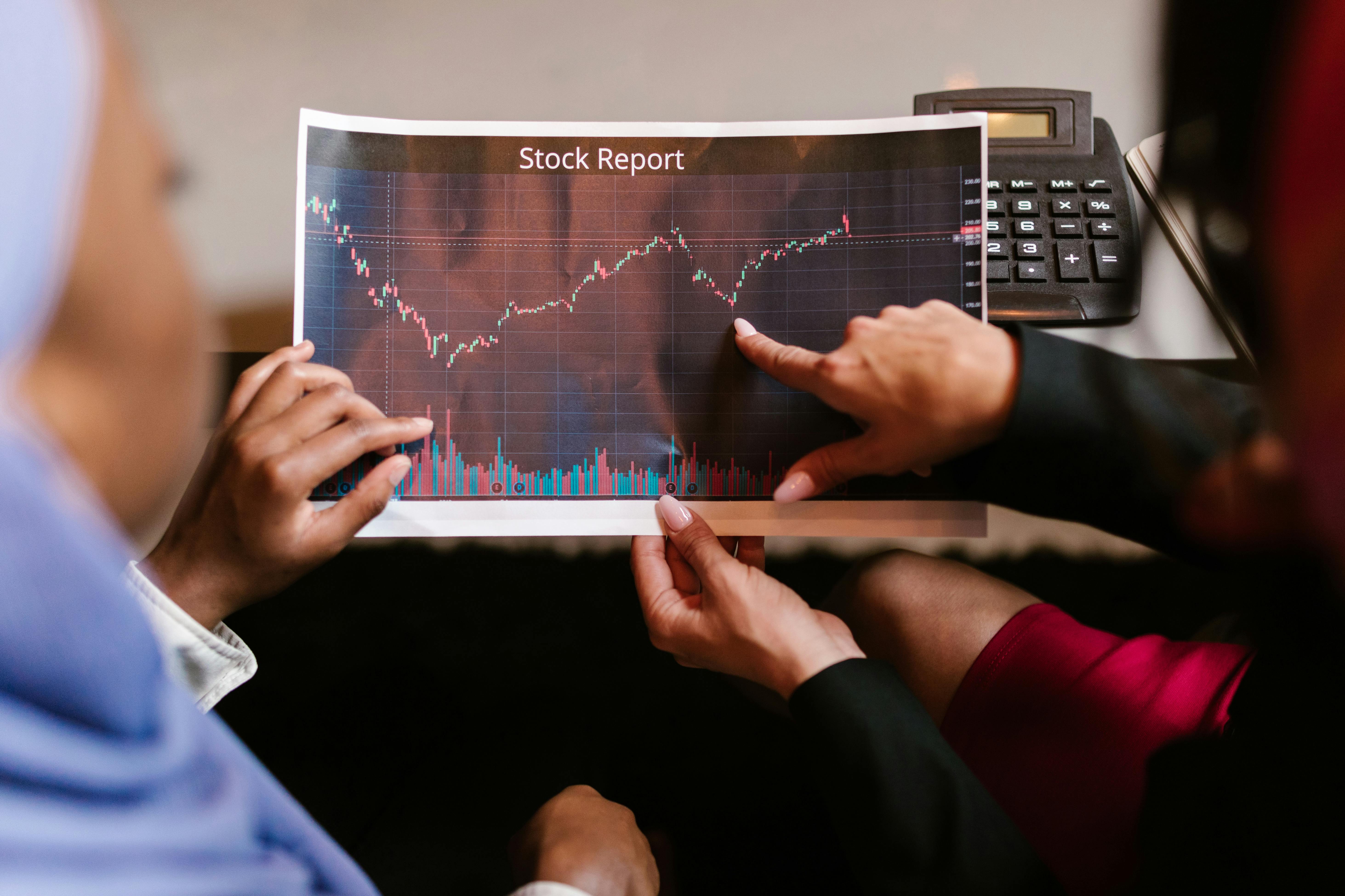 People checking a stock report | Source: Pexels