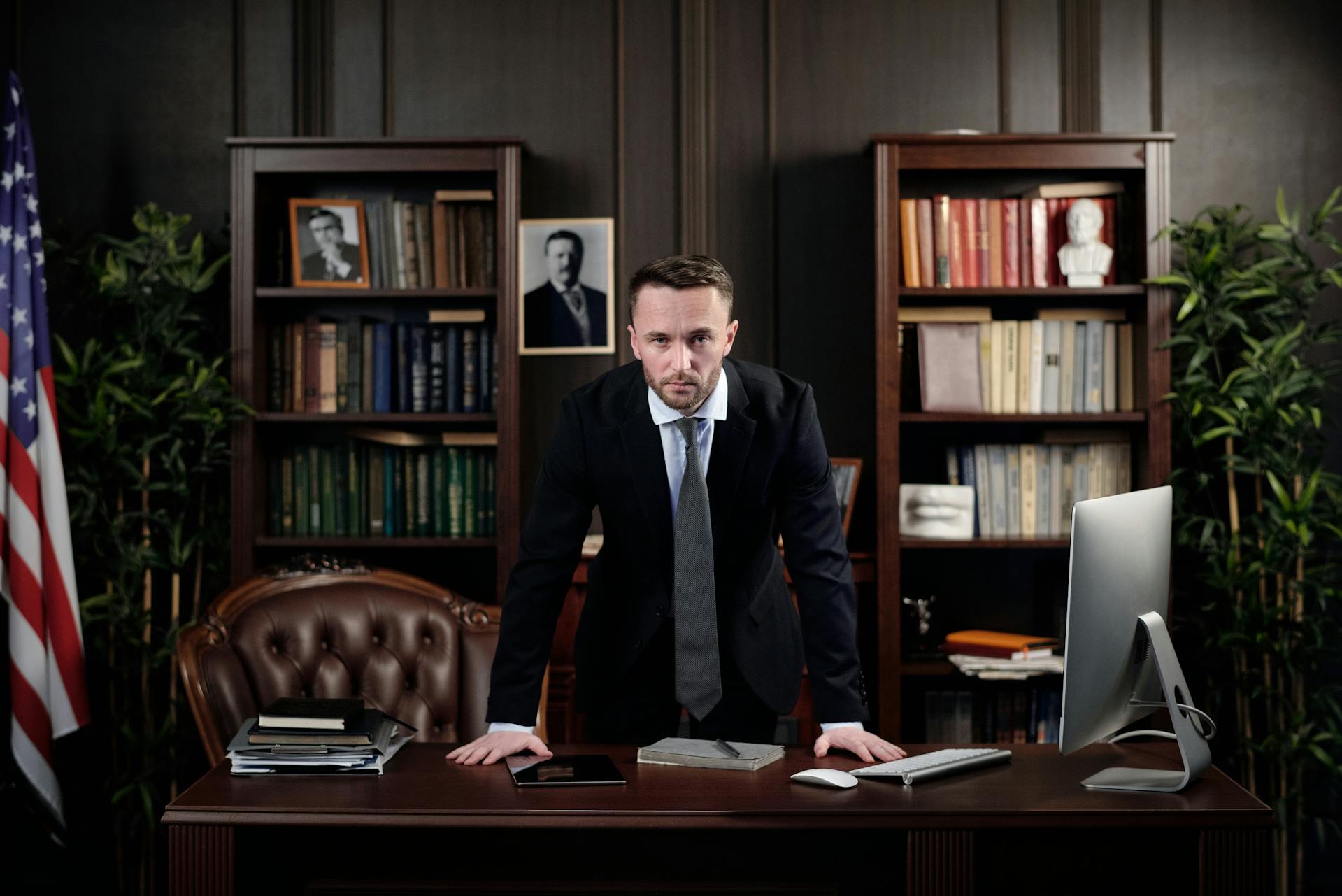 A serious-looking man behind a desk in an office | Source: Pexels