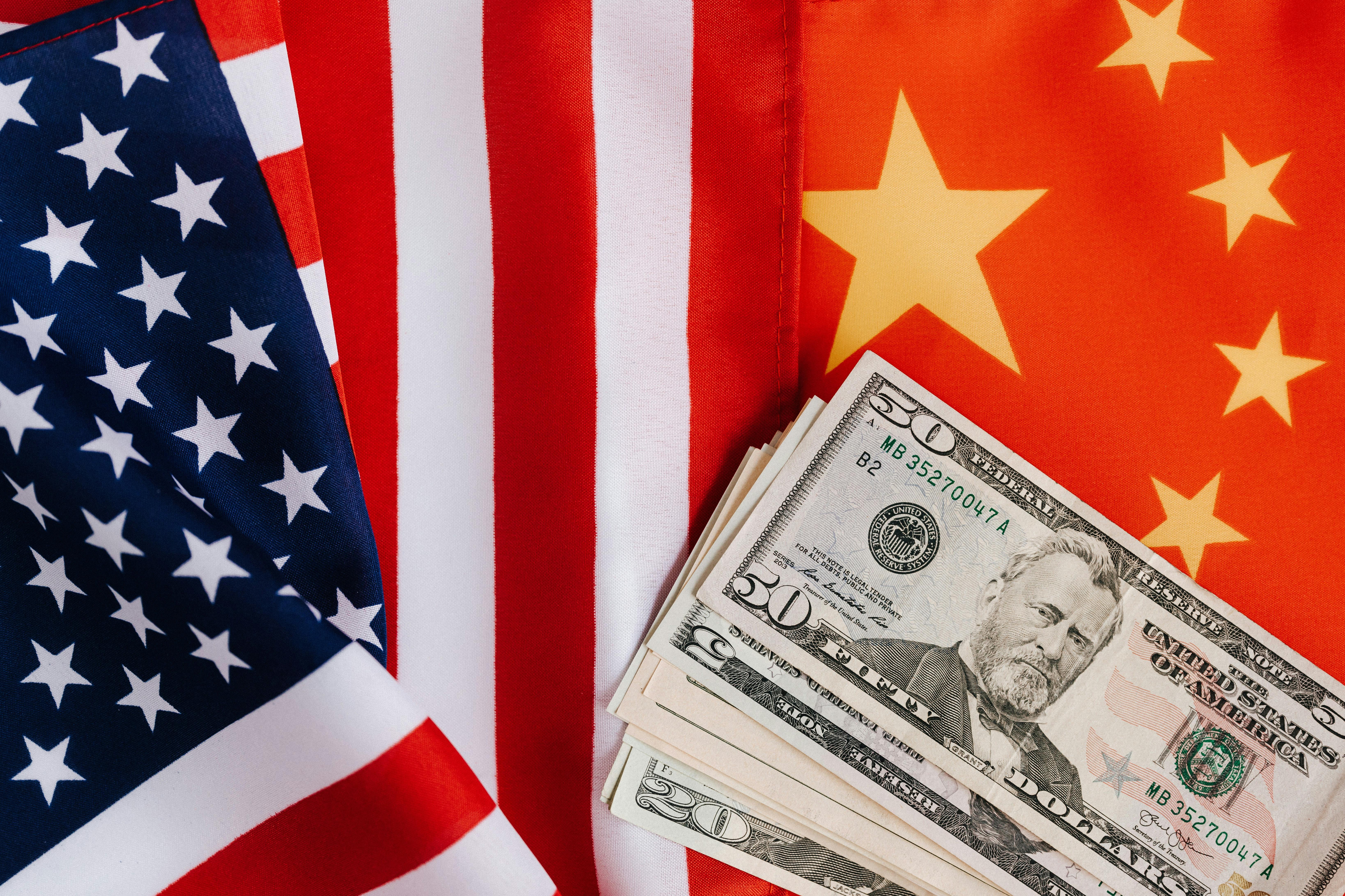 USA and China flags under dollar bills | Source: Pexels