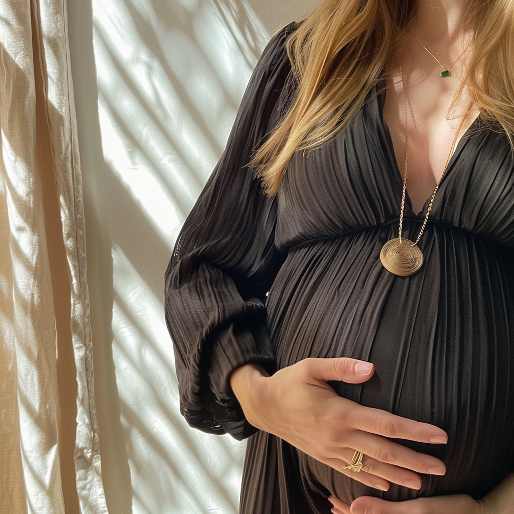 A pregnant woman holding her stomach | Source: no source