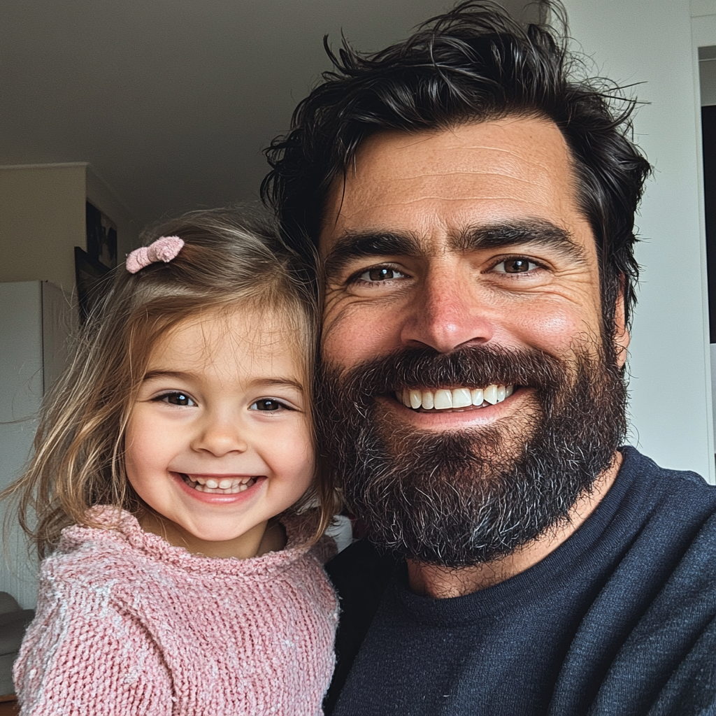 A smiling father and daughter duo | Source: no source