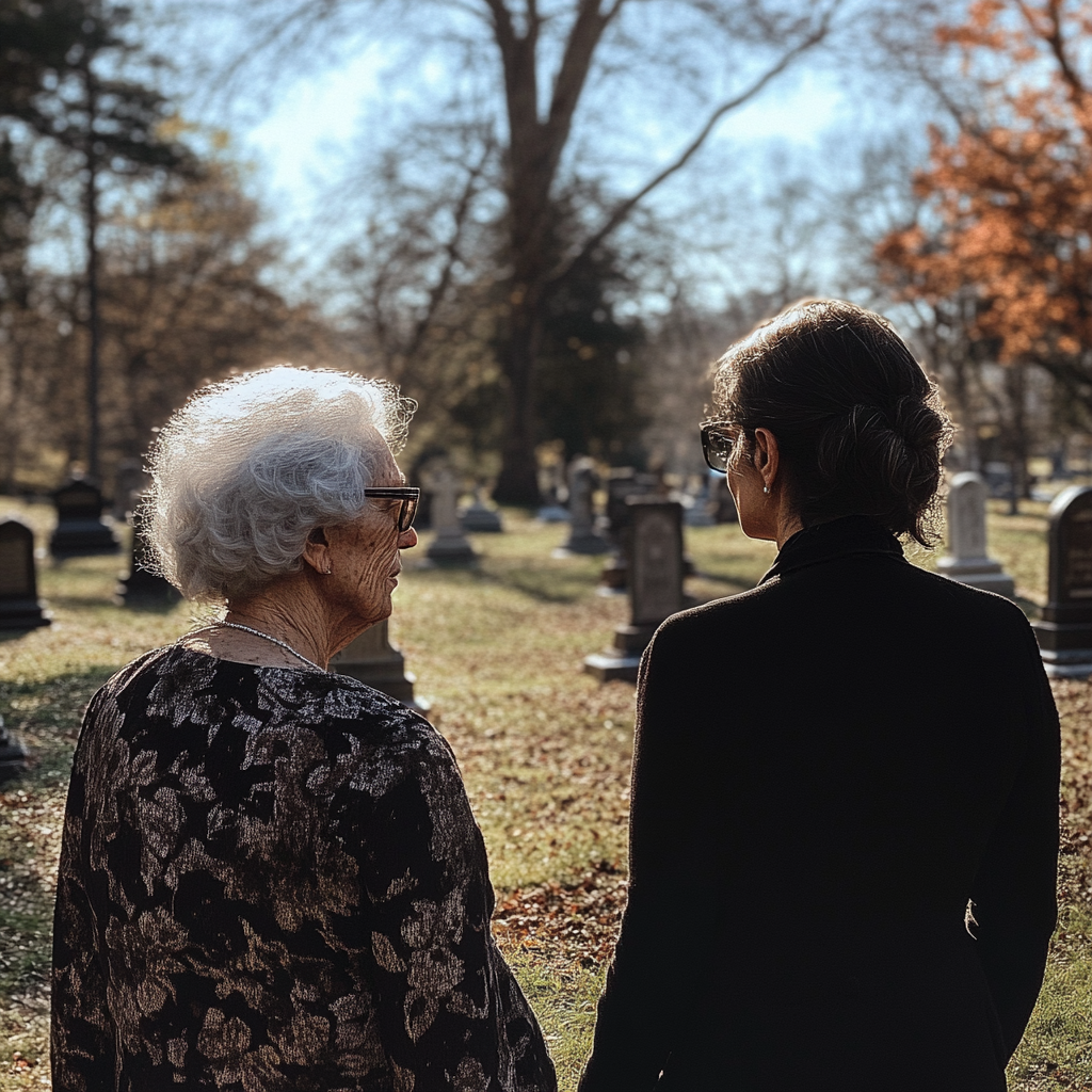 Senior woman and a young woman at a gravesite | Source: No source