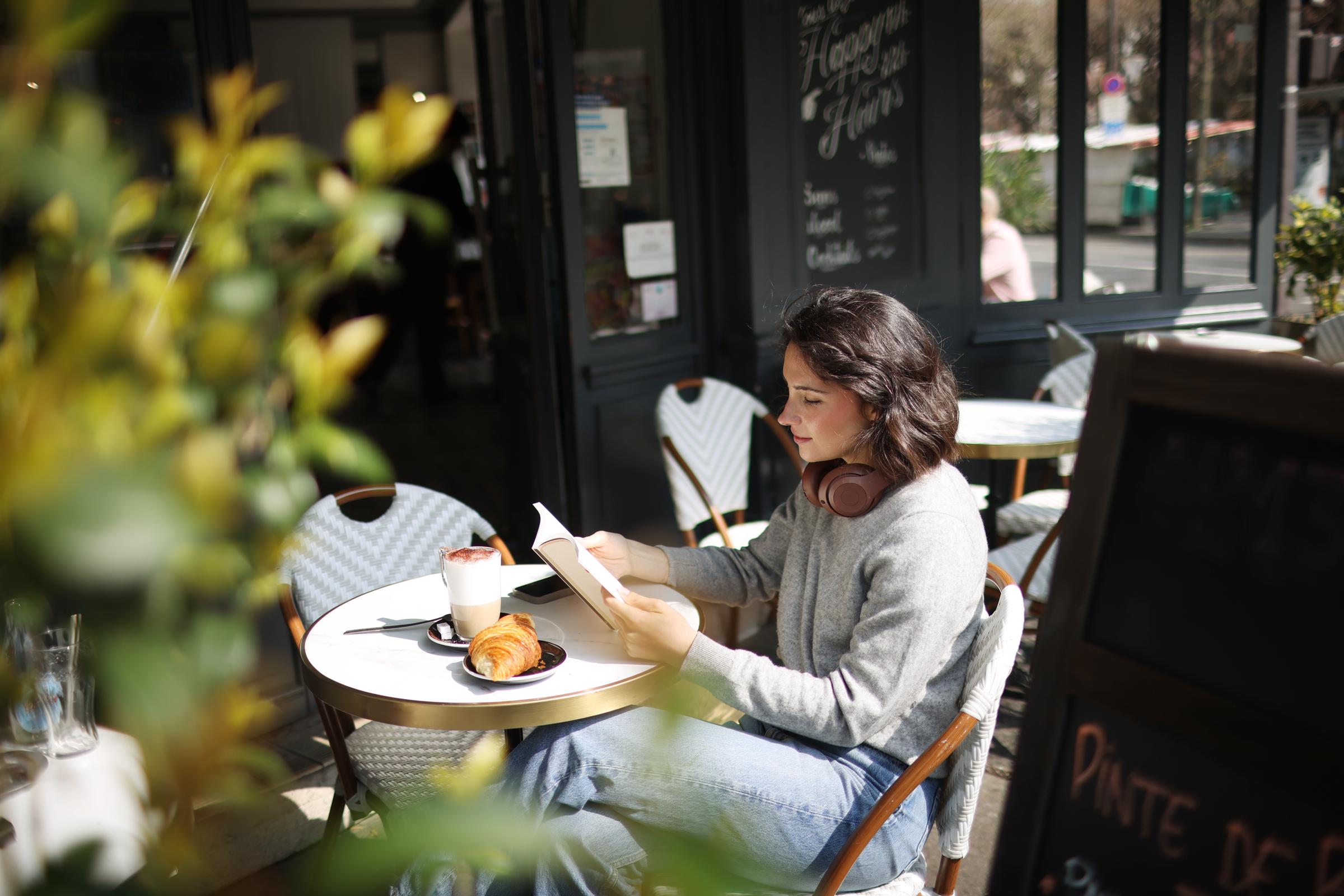 A young woman reading at a cafe | Source: Getty Images