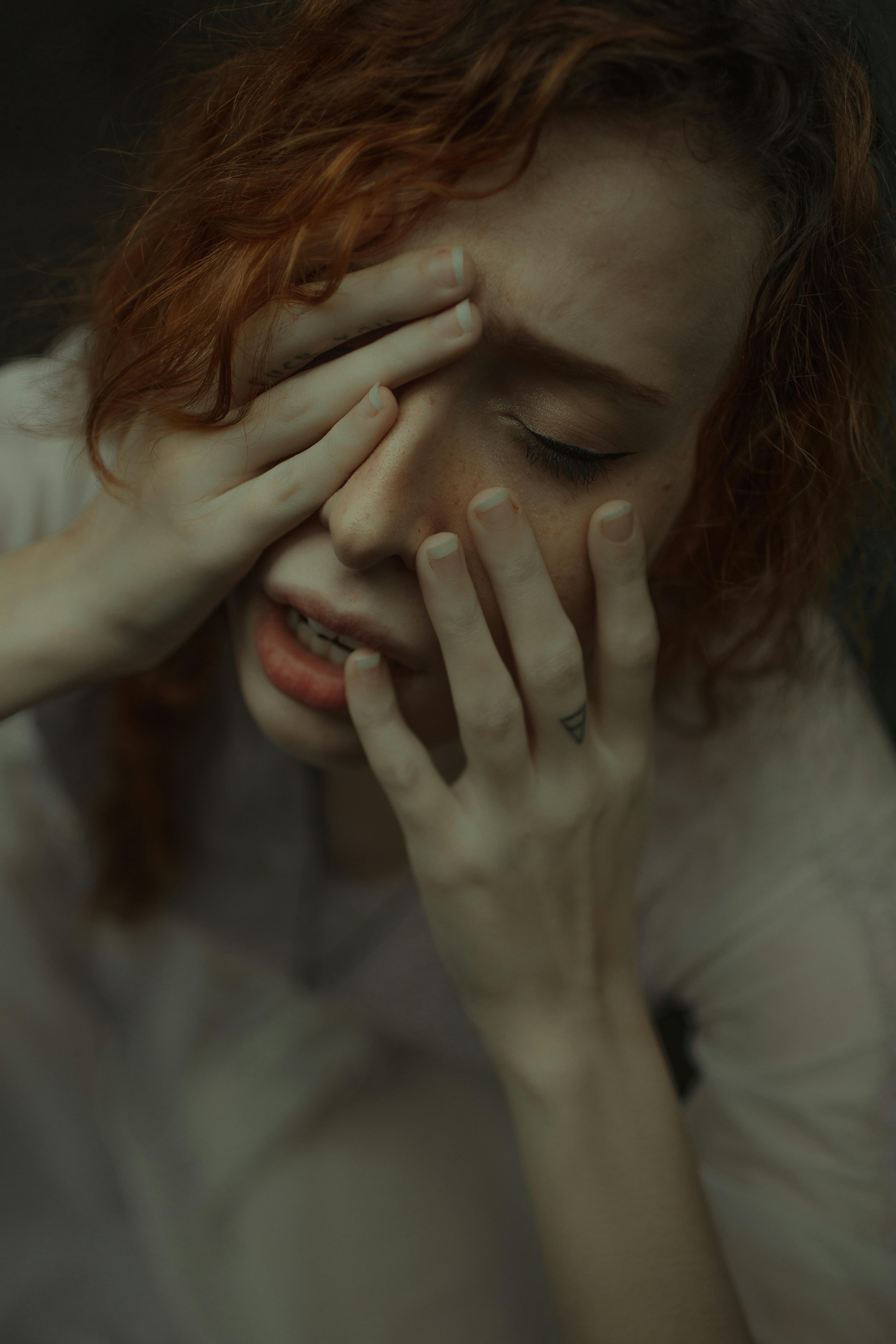 A woman holding her face | Source: Pexels