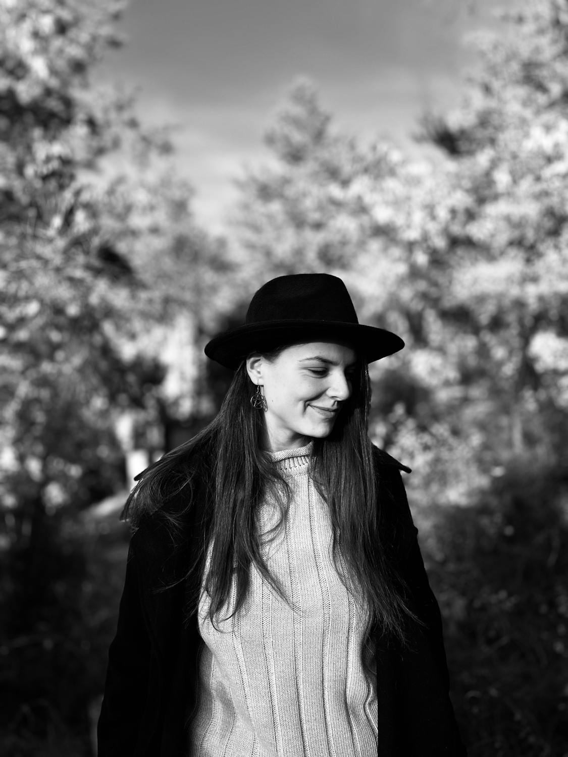A smiling woman in an orchard | Source: Pexels
