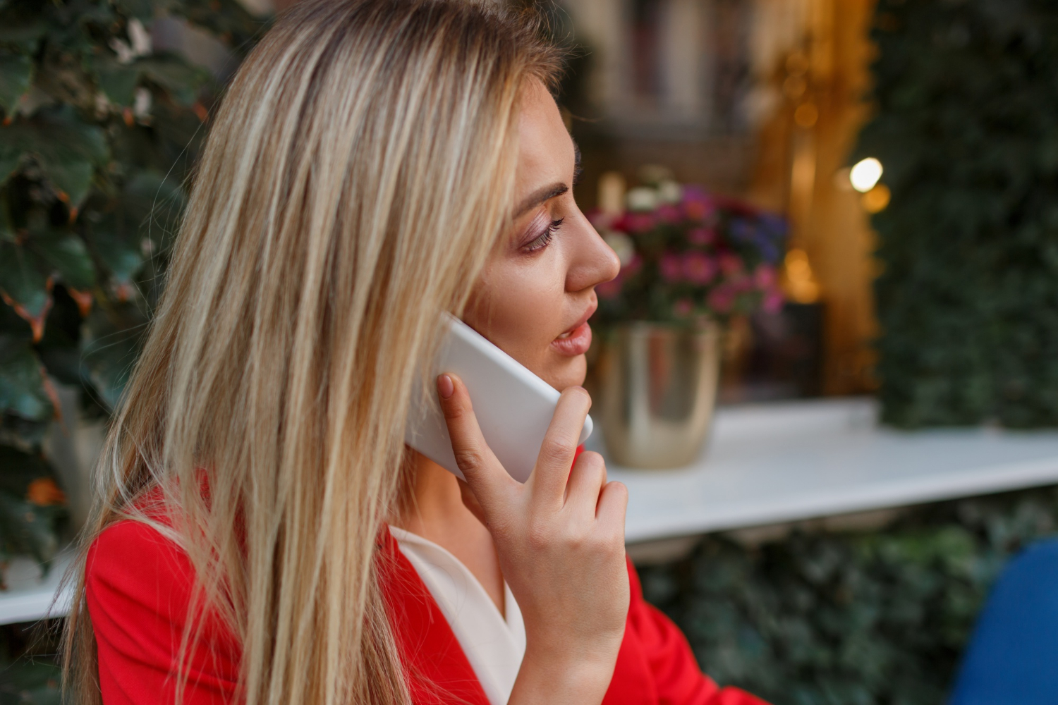 A woman talking on the phone, looking casual and bored | Source: Freepik